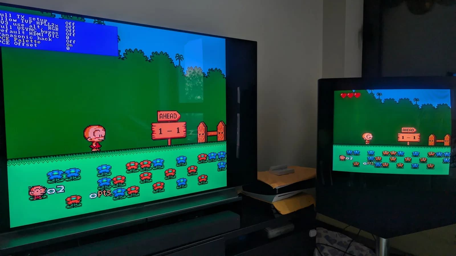 PC Engine Bonk level on two displays; the left (flat-panel TV) shows the game via RGB through the OSSC with the composite-palette emulation ON (its sideloaded experimental firmware), the right a CRT showing the CoreGrafx's direct composite output for comparison.
