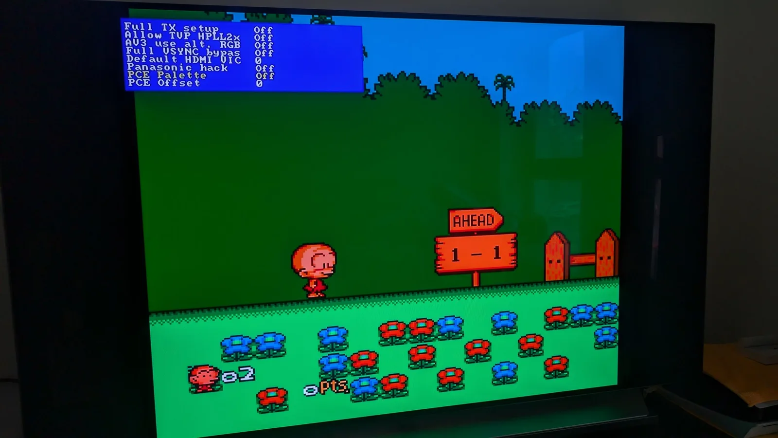 The PC Engine Bonk level running via RGB through the OSSC with the composite-palette emulation OFF, on a flat-panel TV, the OSSC settings menu overlaid top-left ('PCE Palette' Off, 'PCE Offset' 0).