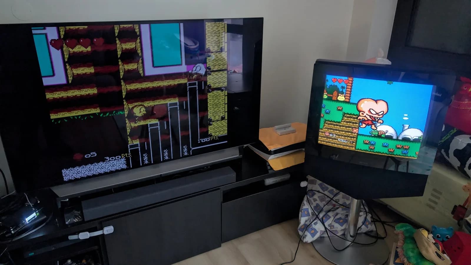The same PC Engine game (Bonk's Adventure) on two displays for comparison: a large flat-panel TV on the left, fed through the OSSC, and a CRT on a stand on the right, driven directly from a separate console.