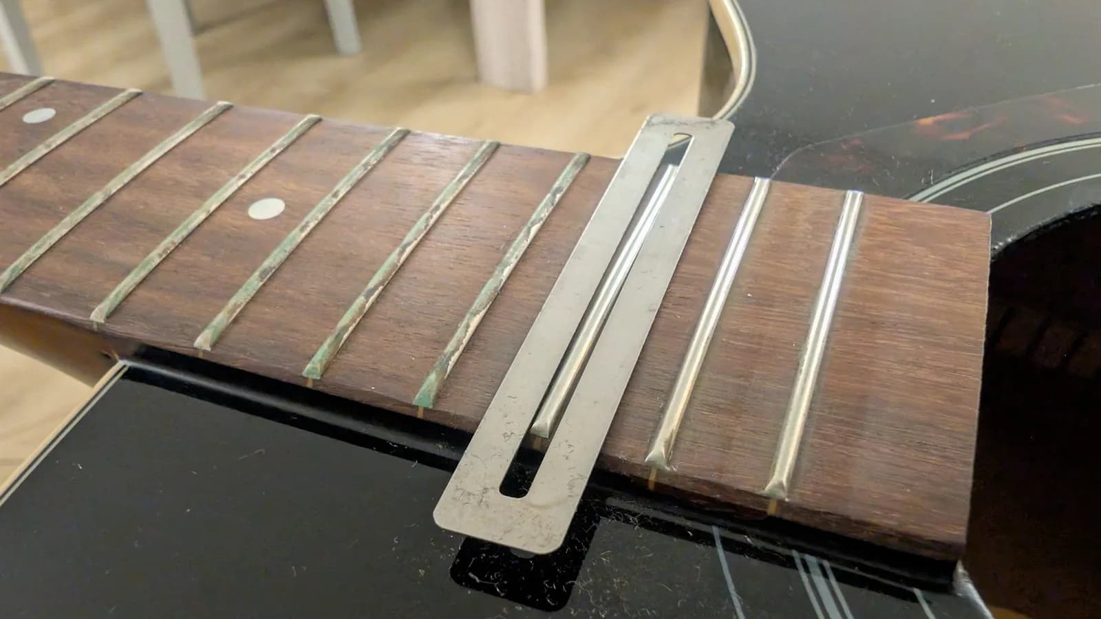 Yamaha FX370C fretboard with fret guard installed over frets during oxidation removal, strings removed for cleaning.