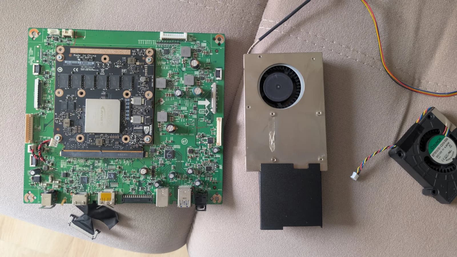Asus PG27UQ mainboard with replaced fan and thermal paste applied; G-Sync module visible with cooling solution installed.