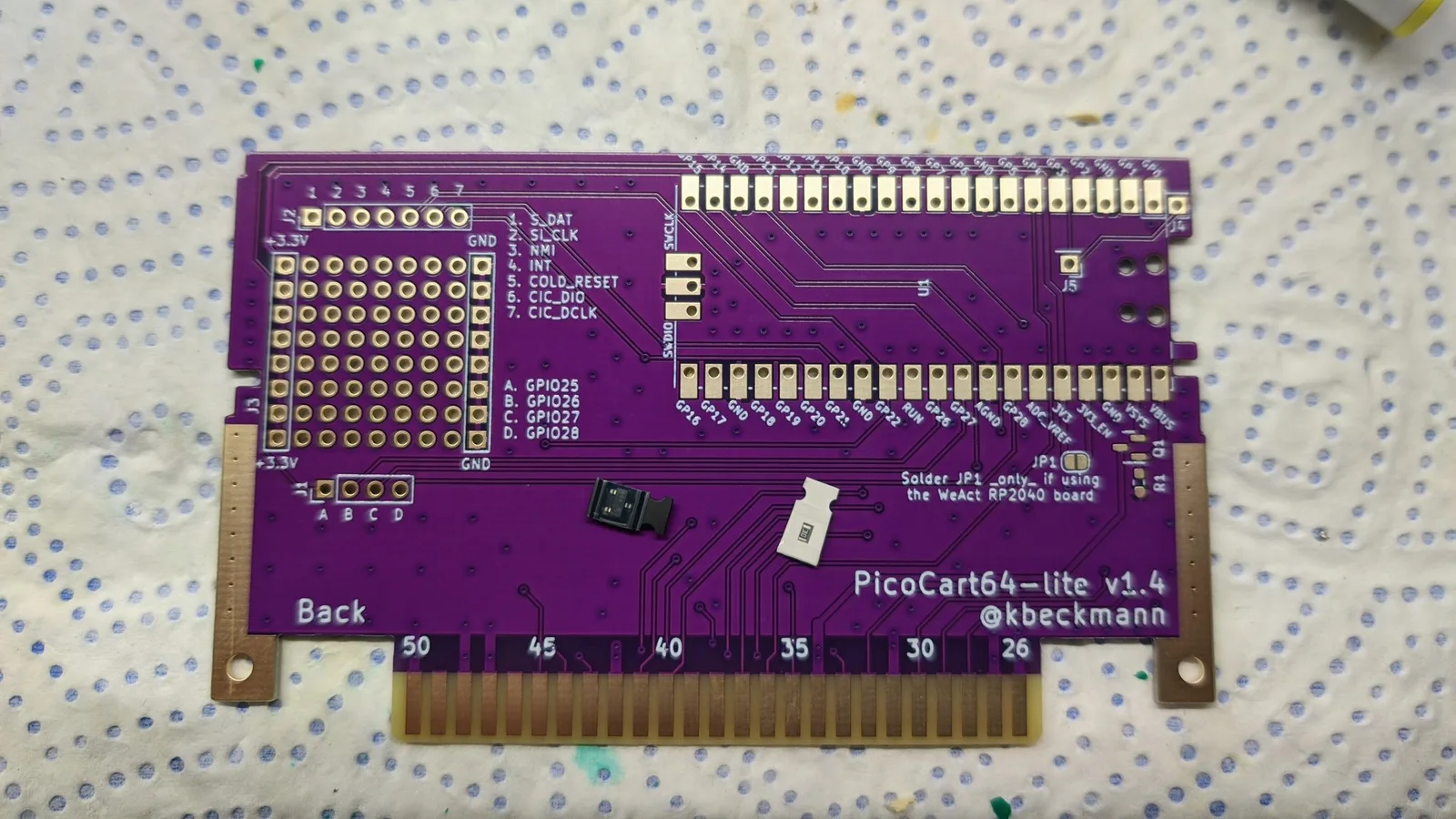 PicoCart64-lite v1.4 PCB back side showing GPIO pins, cartridge connector, and solder joints on breadboard pattern.