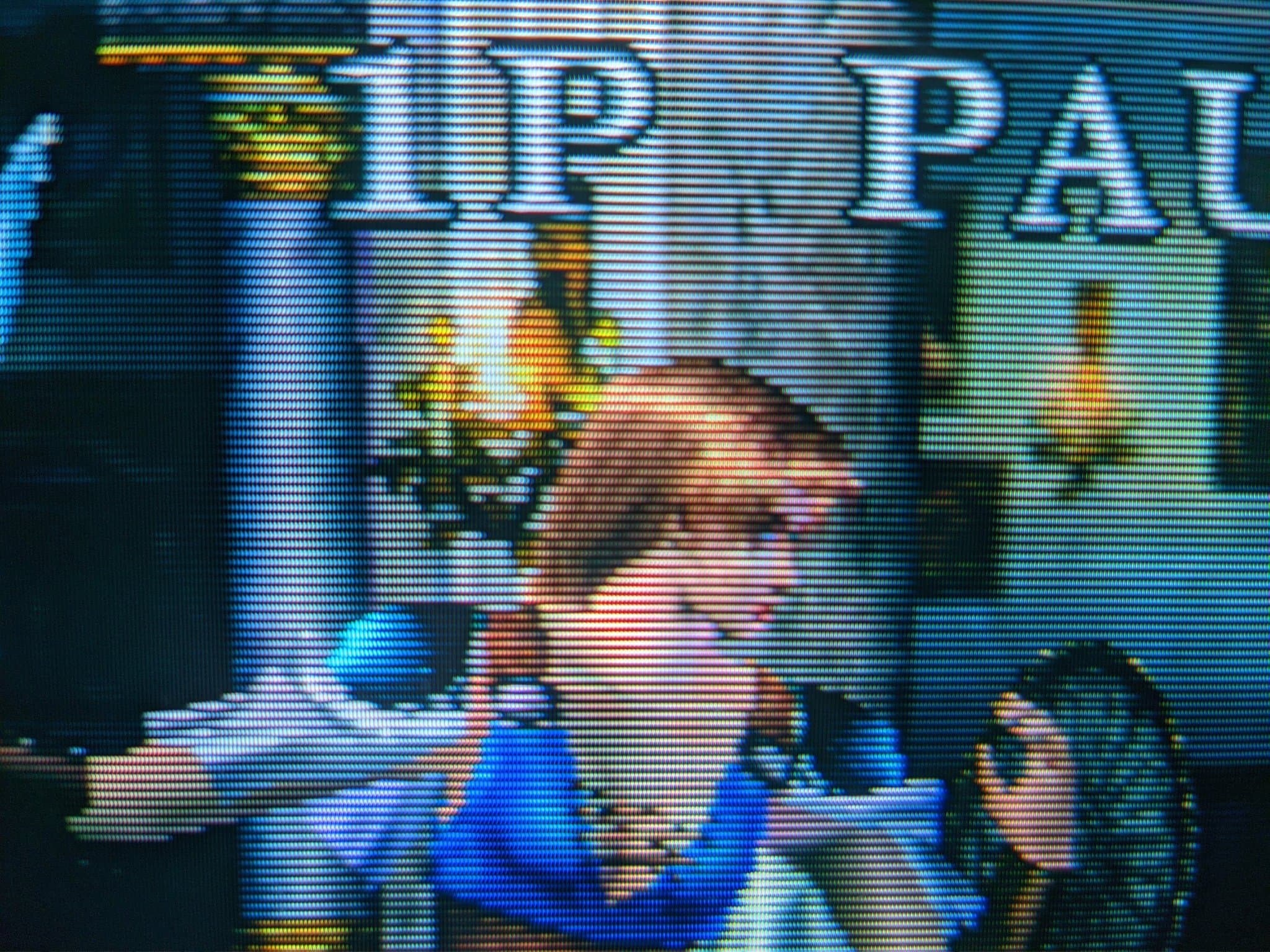 Macro close-up of a Sony Trinitron CRT showing its aperture-grille phosphor stripes while running Soul Calibur.