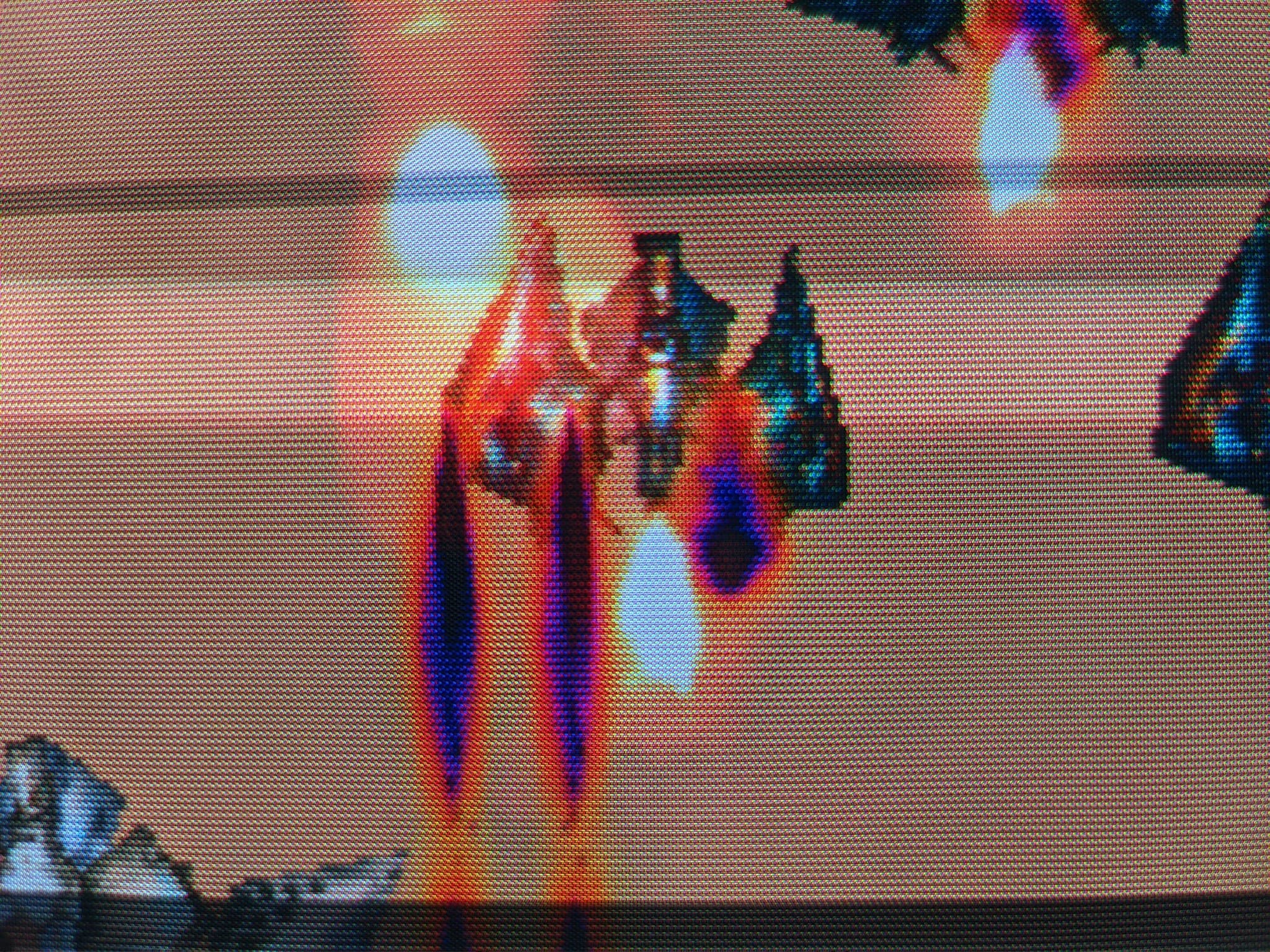 Warm-lit close-up of the Philips 109S4 CRT running Ikaruga, red and blue enemy ships visible.