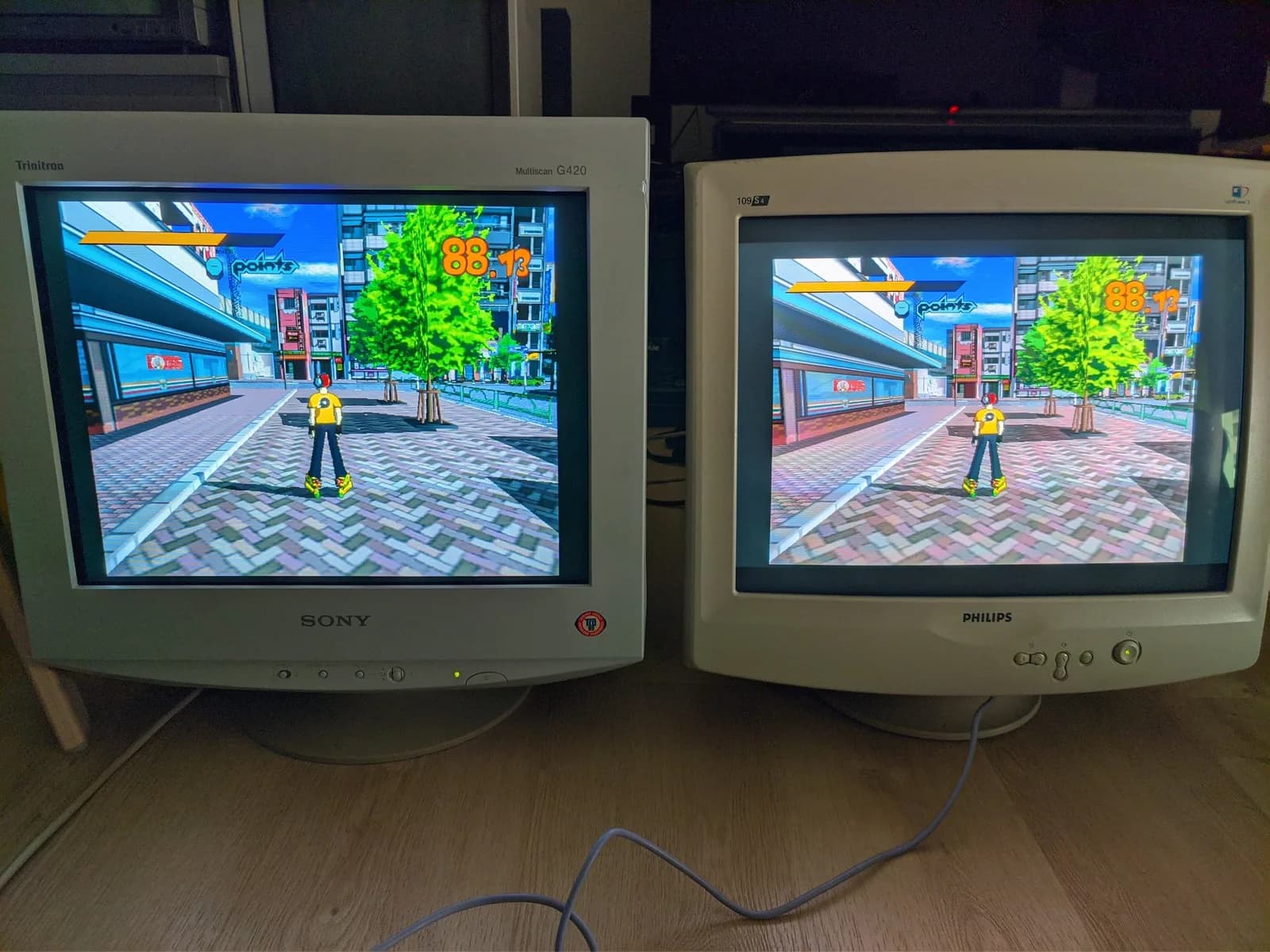 Two CRTs side by side, both fed the same Jet Set Radio signal from one Dreamcast: aperture grille (Sony CPD-G420, left) versus shadow mask (Philips 109S4, right).