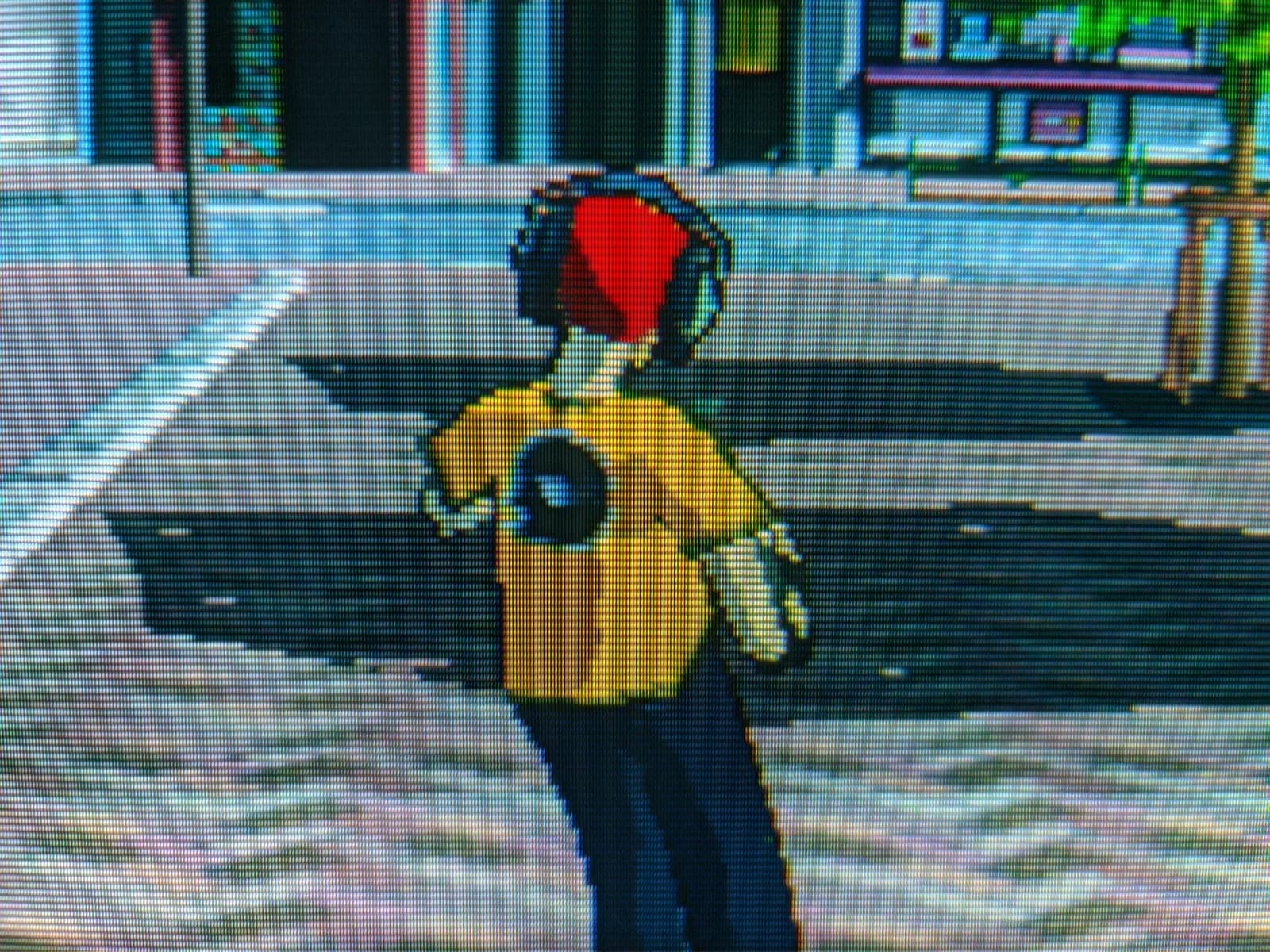 Jet Set Radio on the Sony CPD-G420, a yellow-shirted skater with a red beanie standing in a Shibuya-style street.