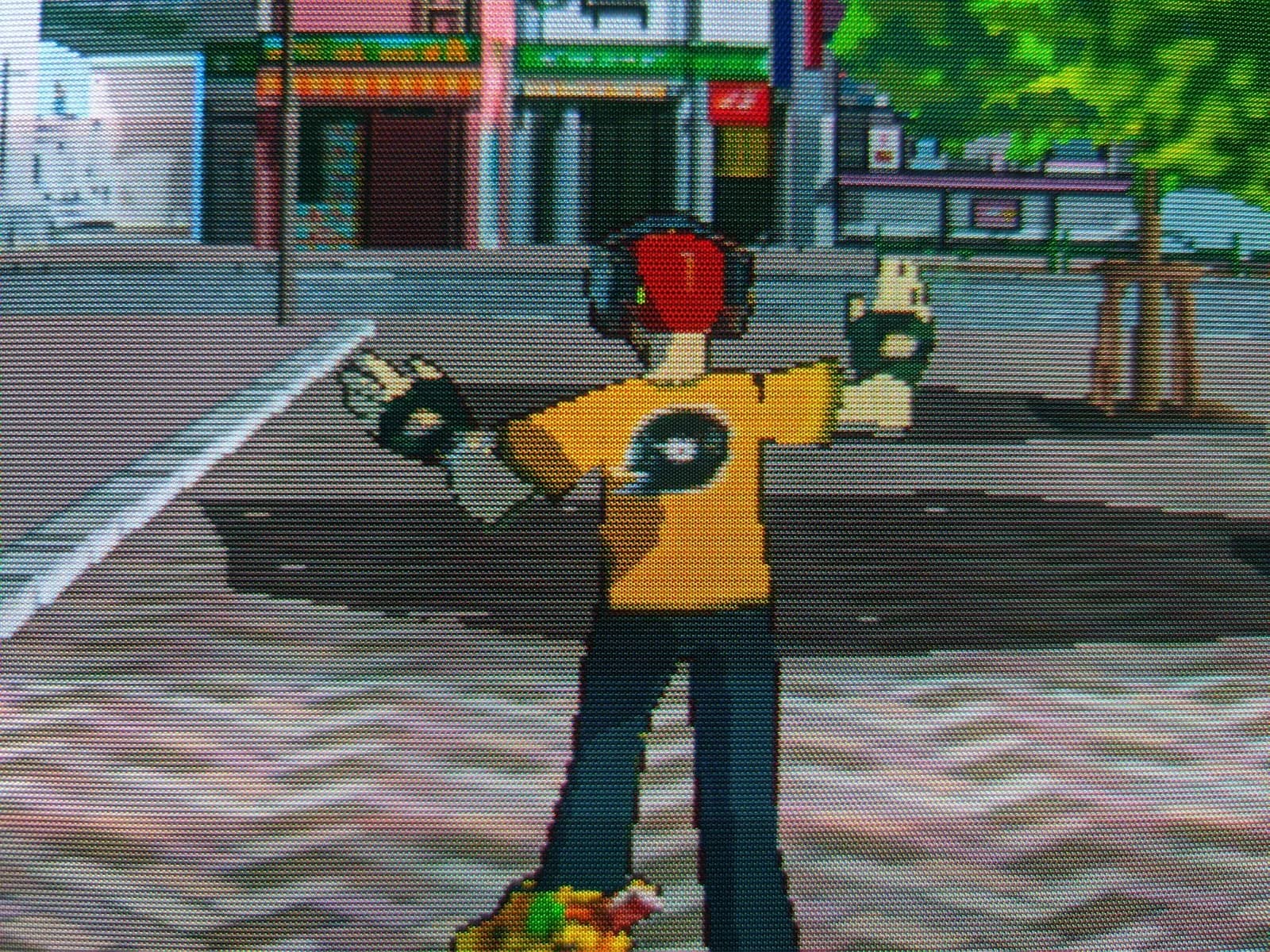 Close-up of Jet Set Radio on the Philips 109S4 shadow-mask CRT, the yellow-shirted skater with a red beanie in a street.