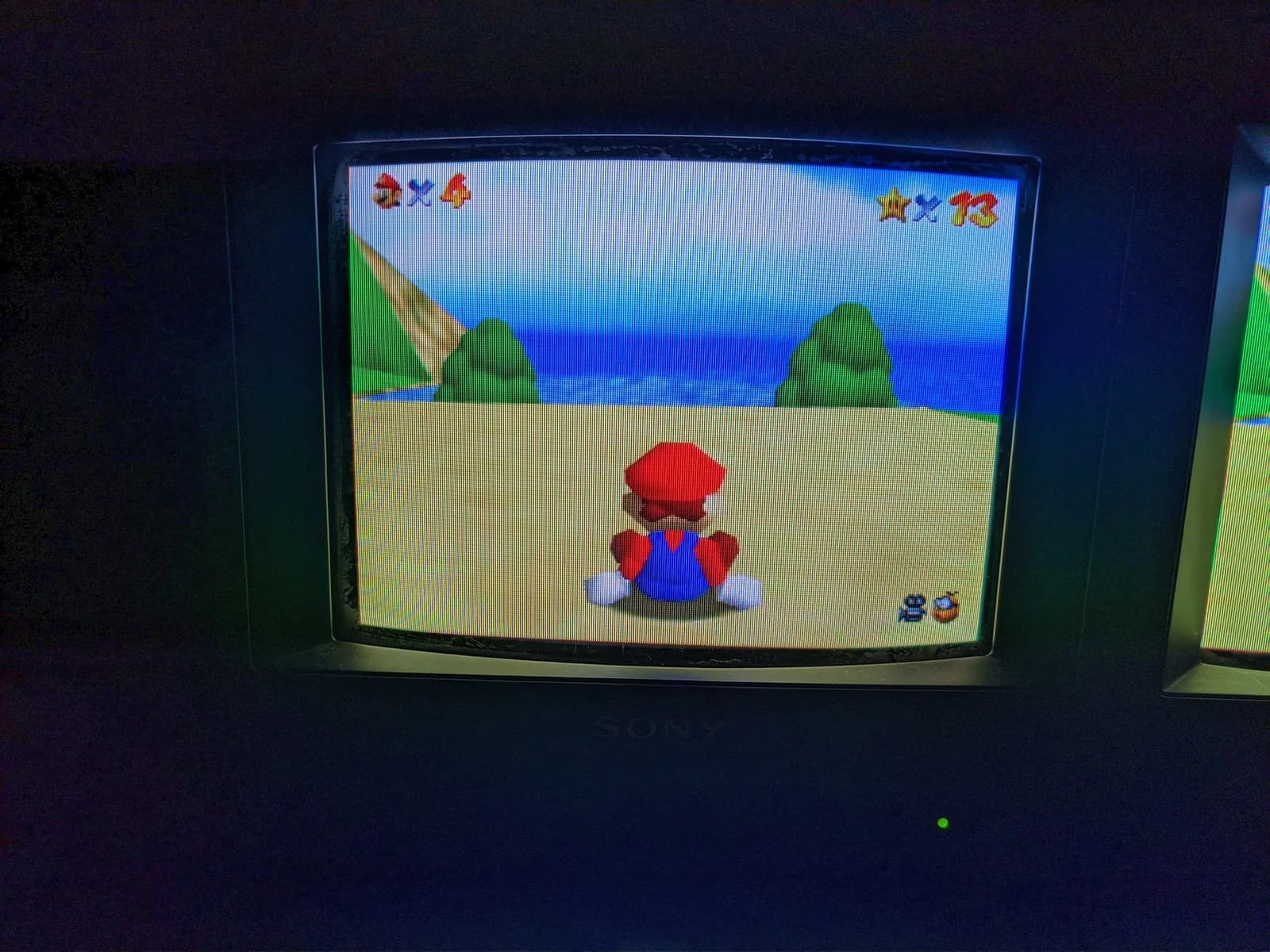 Sony BVM-9045QD displaying Mario character on beach; restored after missing color channel and neckboard repair.