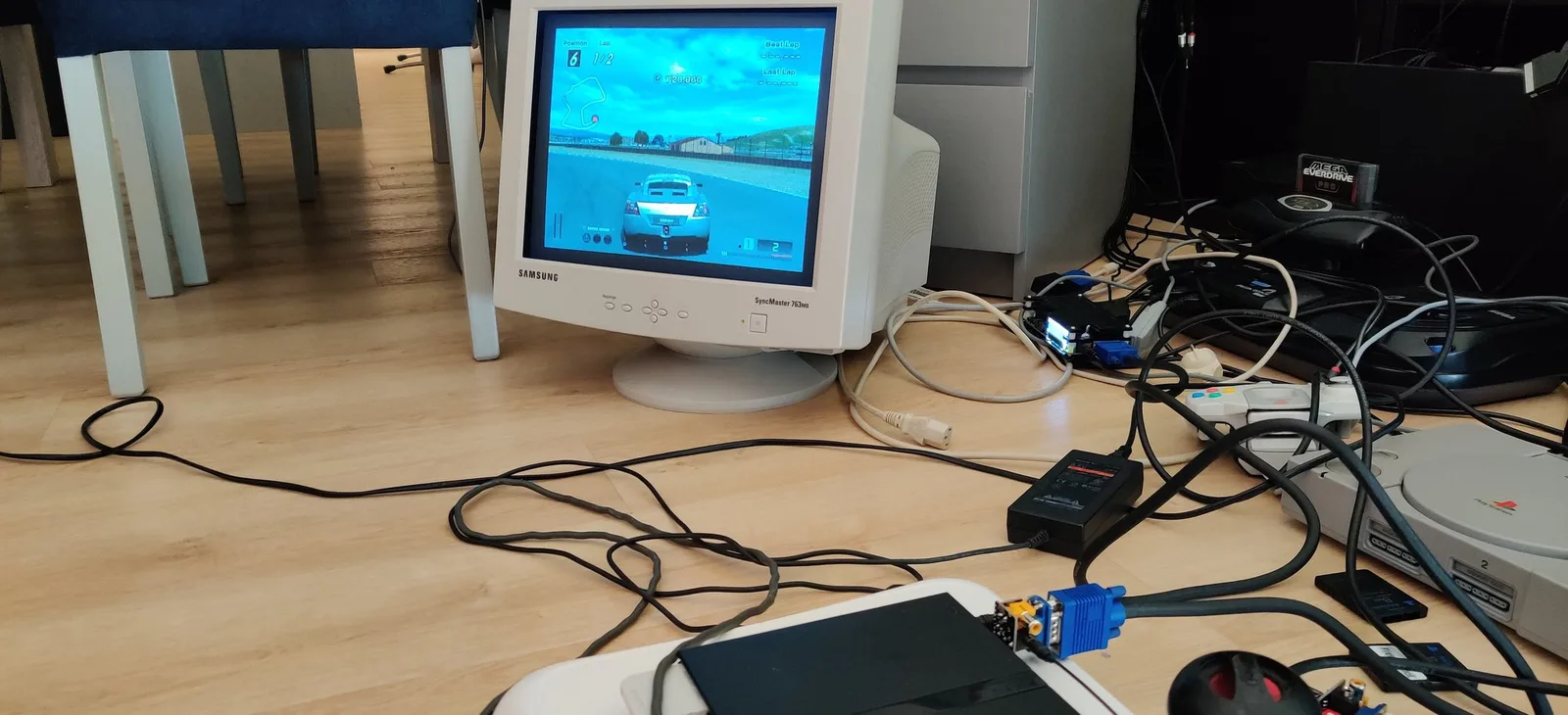 A black PlayStation 2 connected via a Jeff Chen VGA dongle to a Samsung SyncMaster 763MB CRT displaying Gran Turismo 4 gameplay.