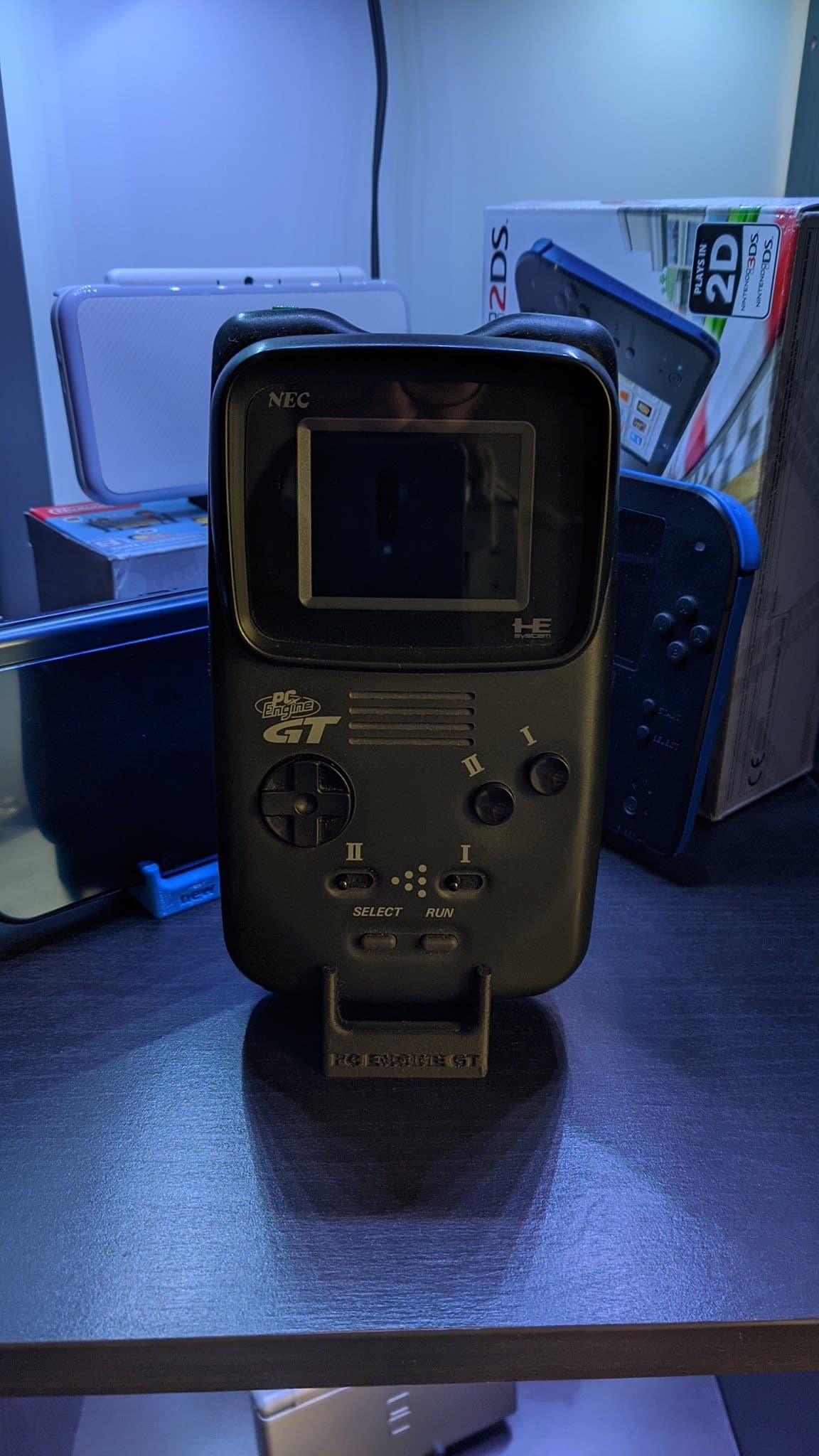 PC Engine GT handheld on a PointerFunction display stand.