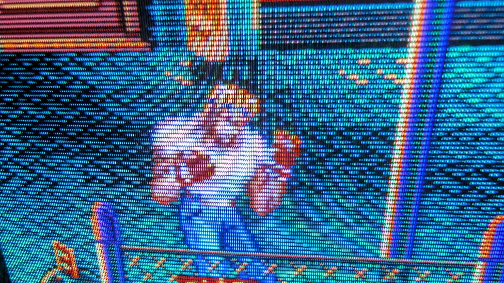 Close-up of PVM-9045QD displaying Streets of Rage 2 from Sega Nomad; visible scan lines and RGB pixel structure show restored deflection board functioning properly.