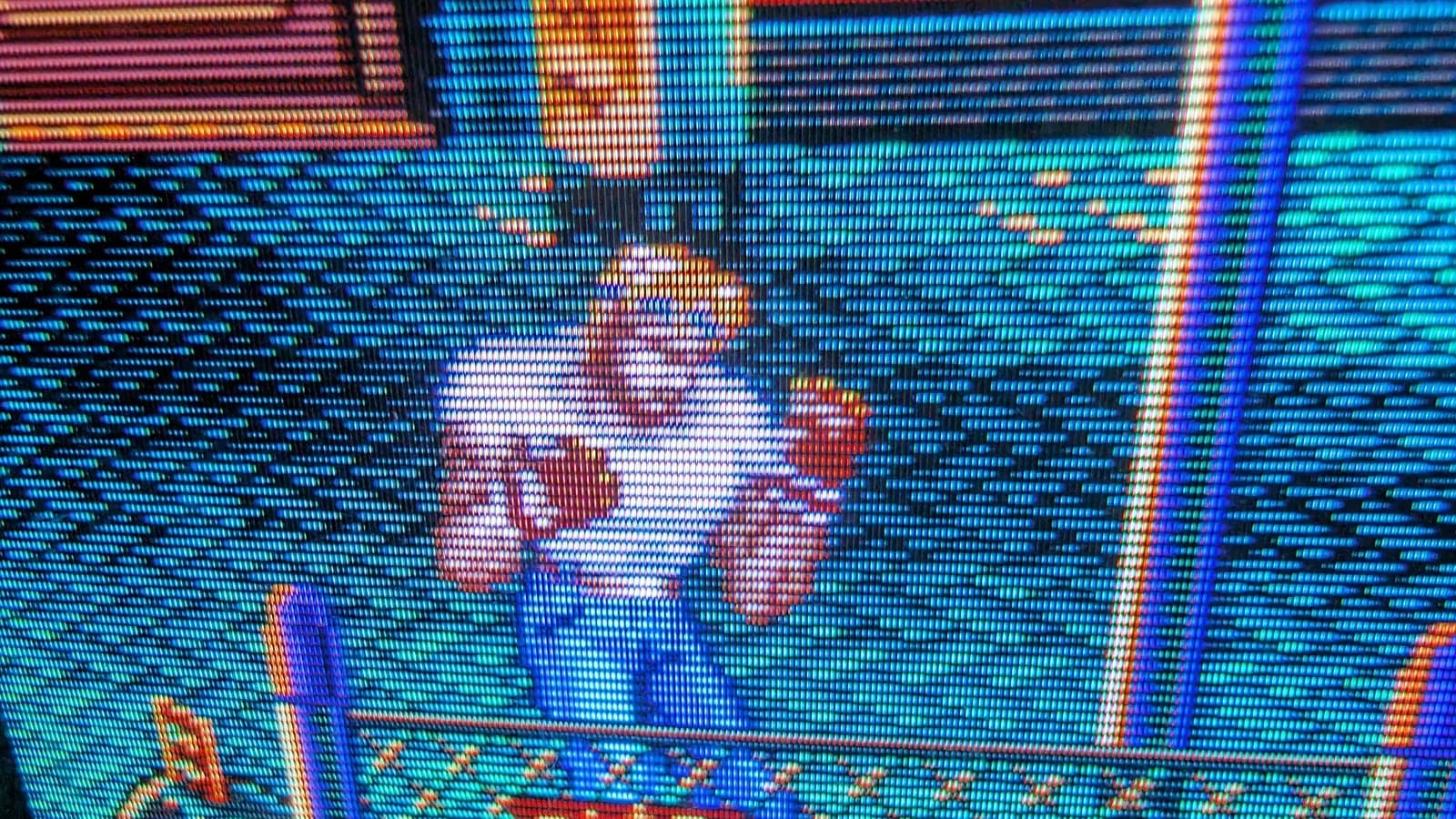 Macro close-up of the Sony PVM-9045QD screen during Streets of Rage 2, the Trinitron aperture-grille RGB stripes and scanlines visible on the sprite.