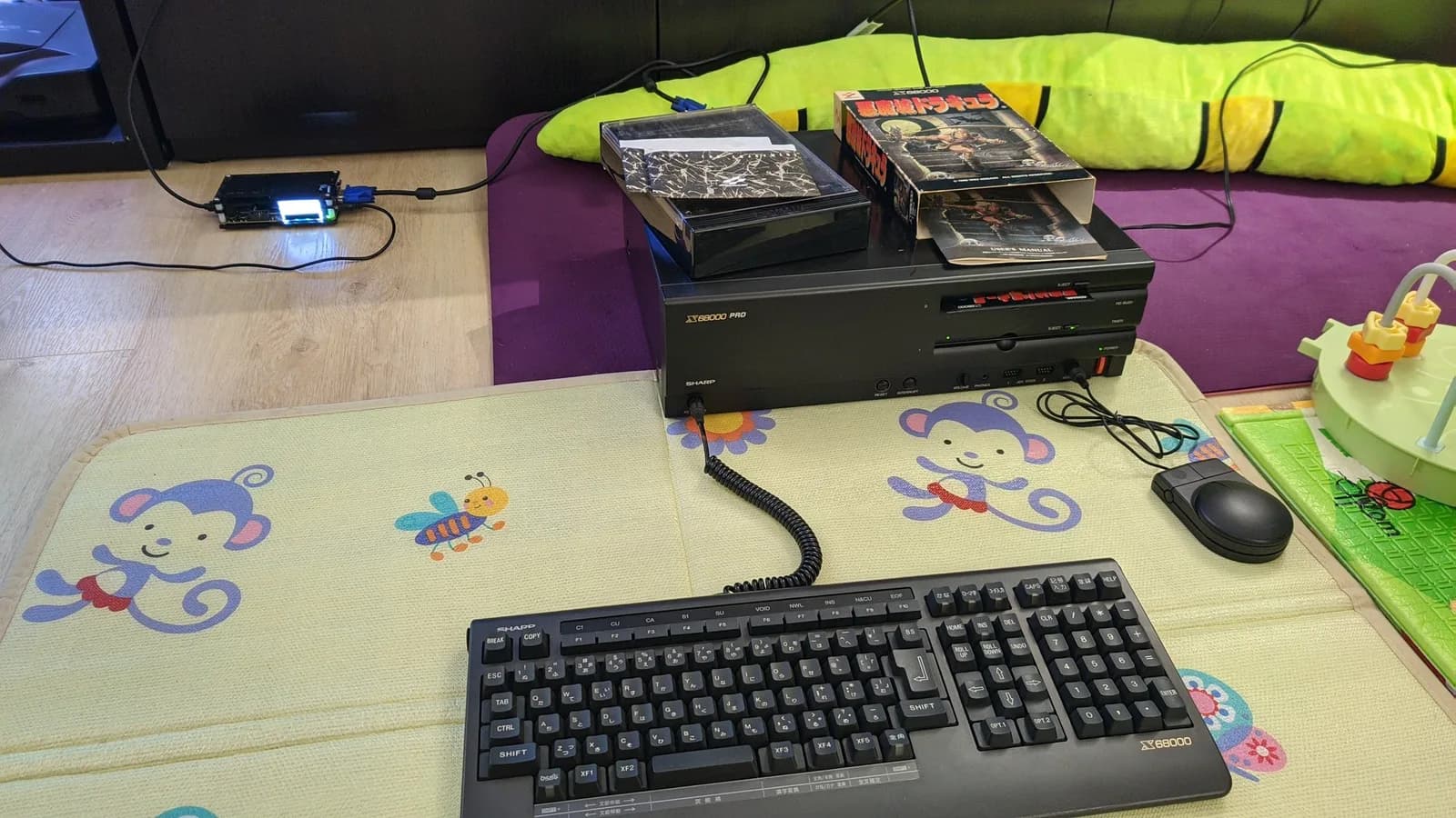 The Sharp X68000 Pro II on the test bench with a keyboard, mouse and Castlevania floppy disks, set up to try the game.