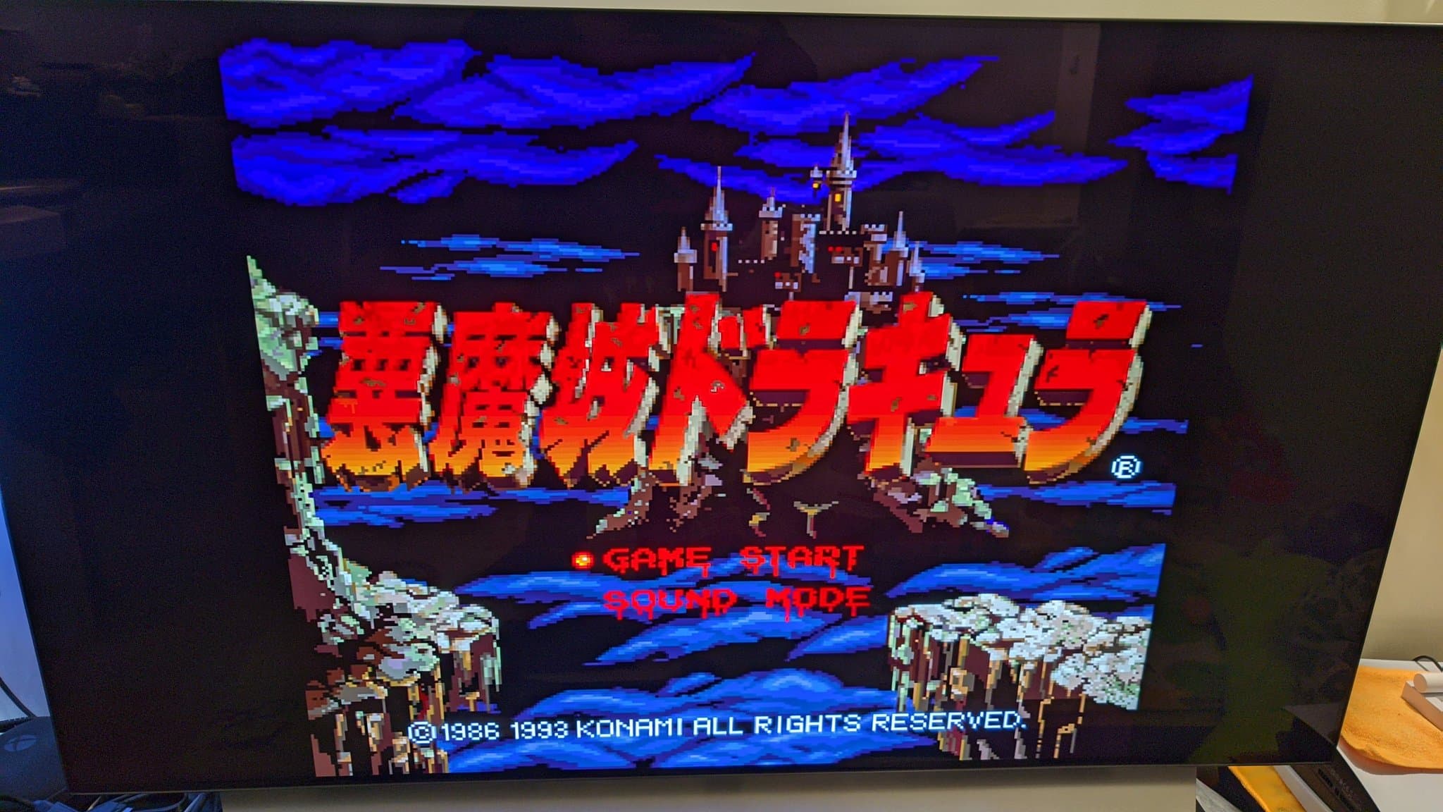The Sharp X68000 Pro II displaying the Castlevania title screen, Japanese text over a castle and blue sky.