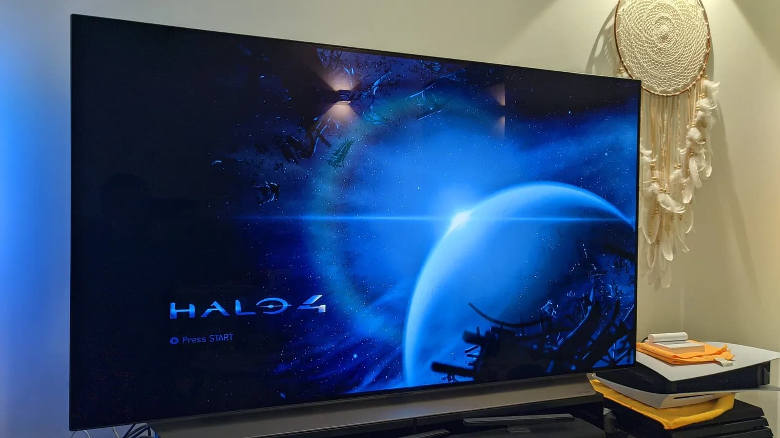 Repaired Xbox 360 connected to a TV showing the Halo 4 title screen, proof the new laser now reads discs after the drive service.