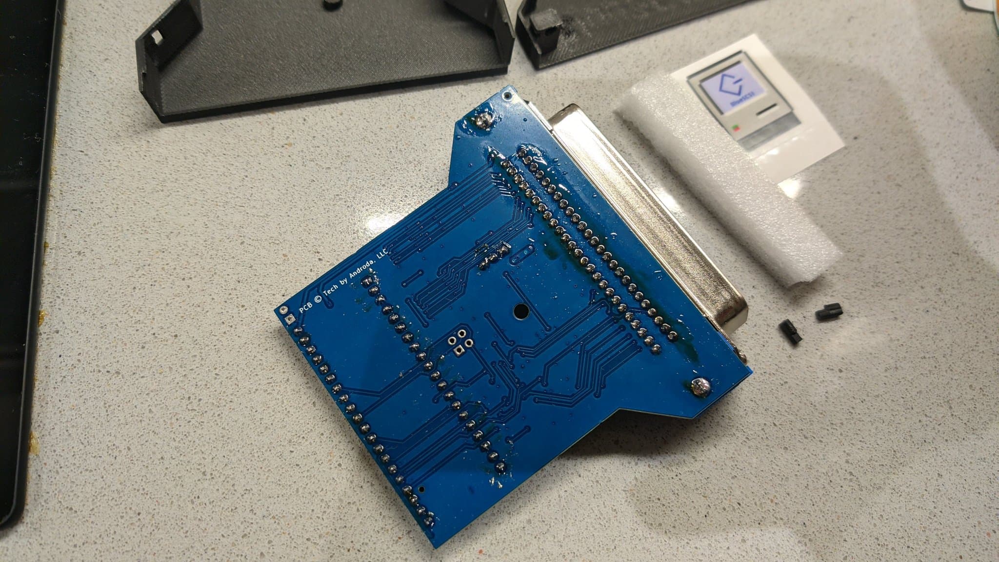 The assembled BlueSCSI v2 PCB with its 50-pin Centronics SCSI connector, all of its solder joints completed and still covered in flux from the build.