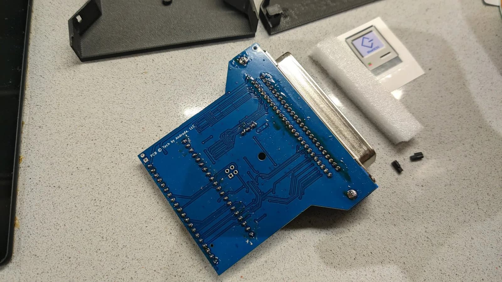 The assembled BlueSCSI v2 PCB with its 50-pin Centronics SCSI connector, all of its solder joints completed and still covered in flux from the build.