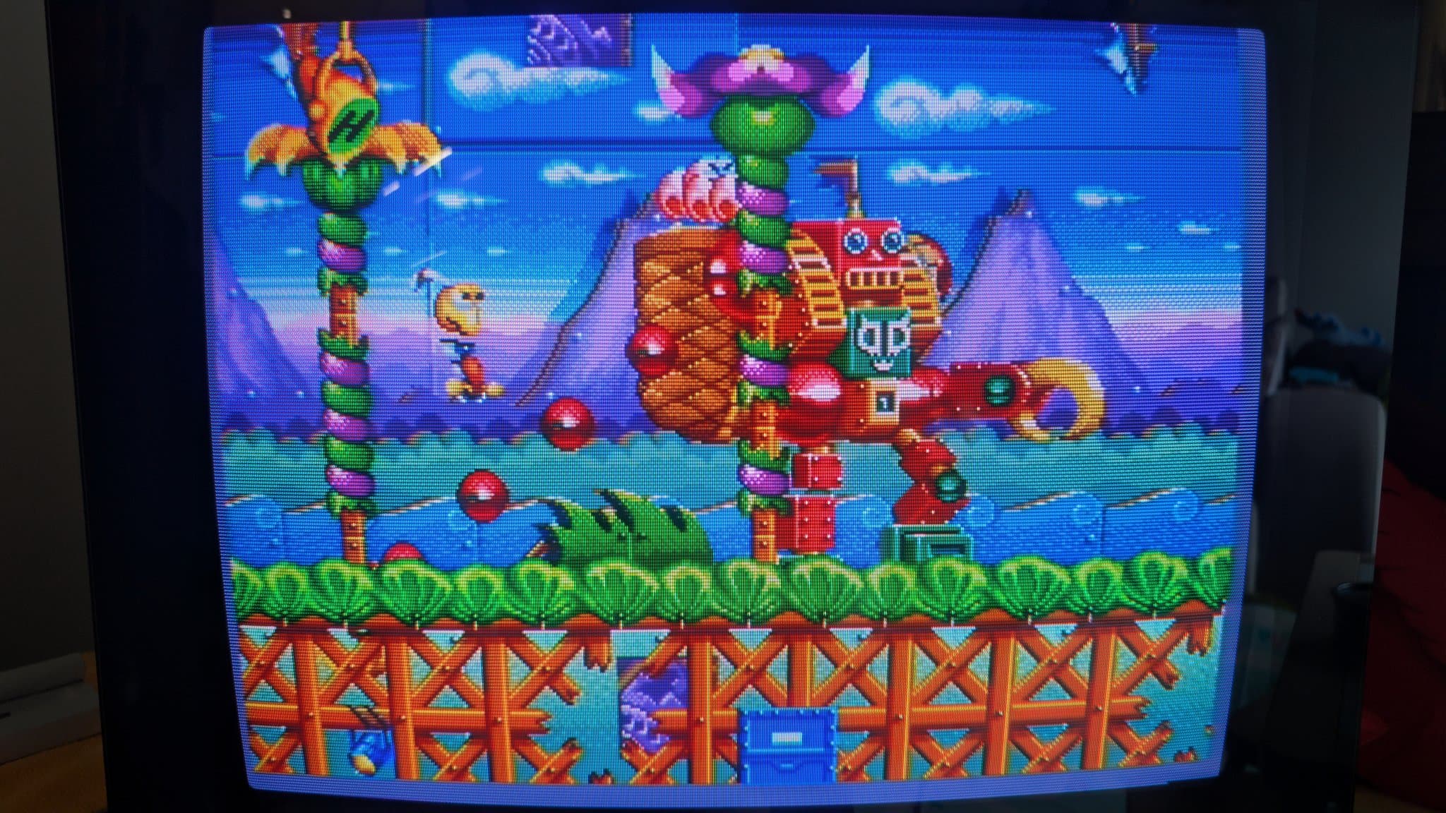 Sega Mega-CD game Road Avengers running on restored Wondermega, showing colorful stage with mechanical castle and totem poles.