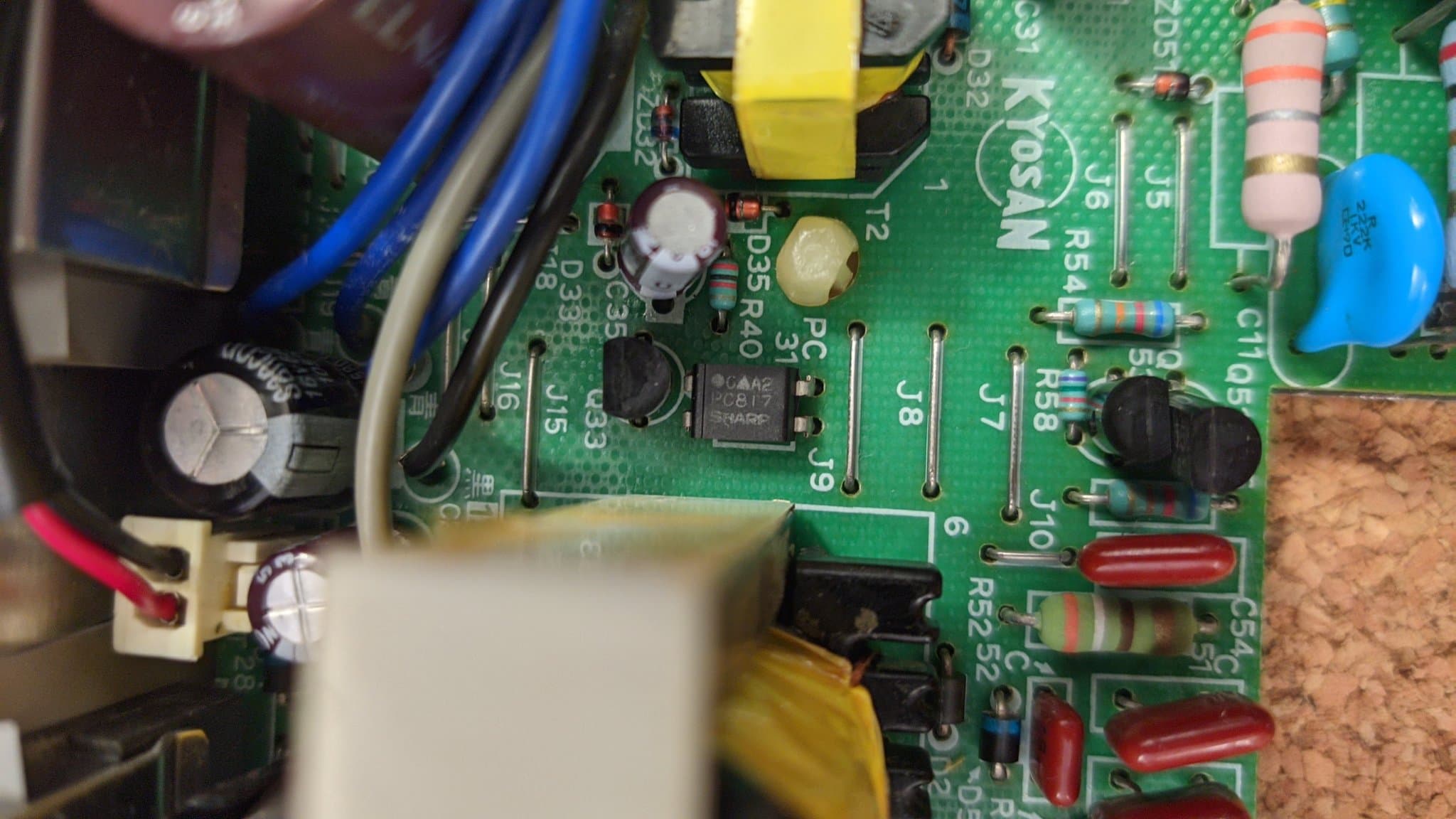 A close-up of the photocoupler on the Sharp X68000 Pro II power supply board; shorting this photocoupler with a probe during voltage testing is what damaged the transistor at Q51 that was later found dead.