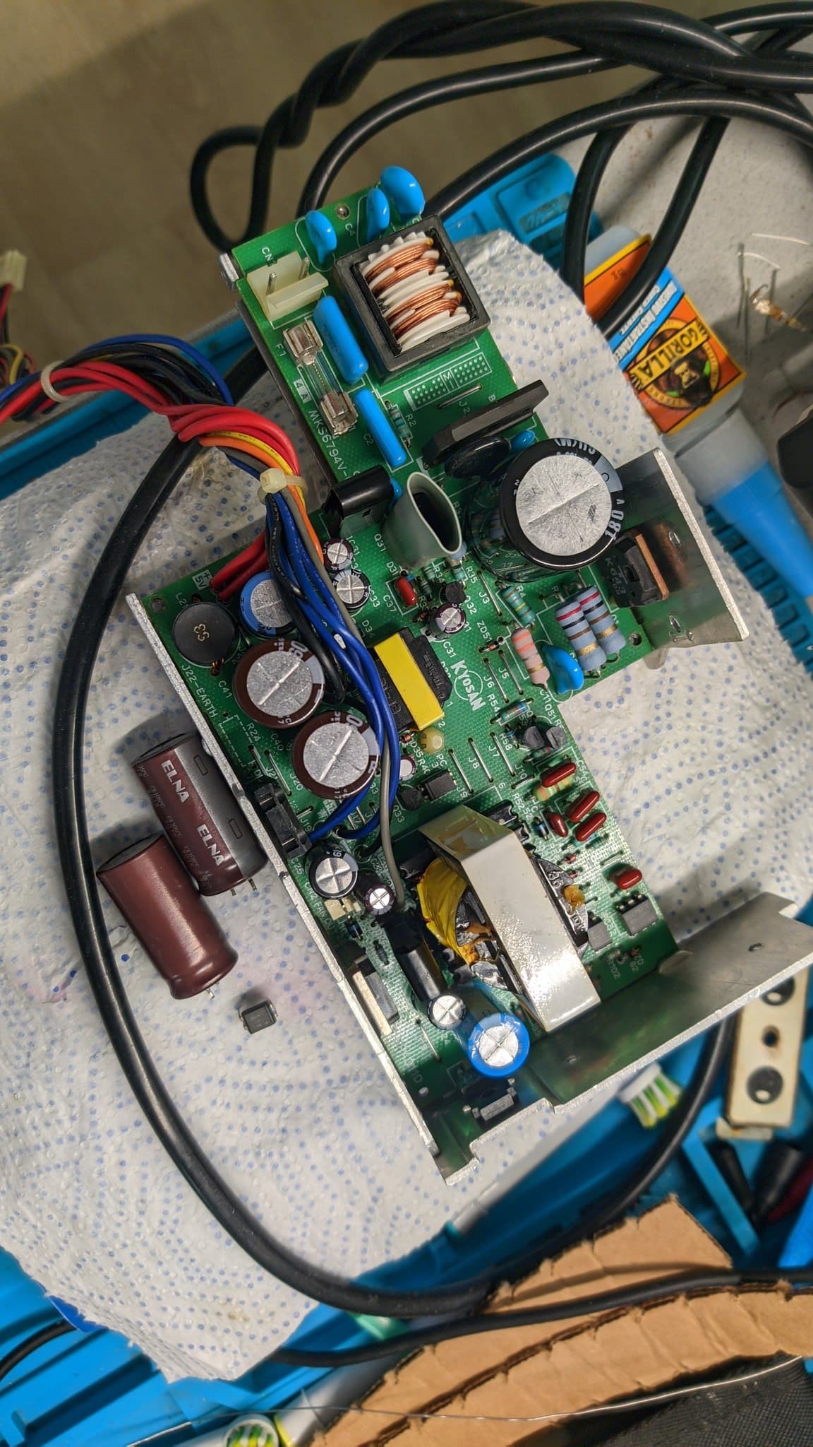 The Sharp X68000 Pro II power supply board after another round of swaps, the remaining old capacitors, a photocoupler, several transistors and zener diodes all replaced, still with no power.