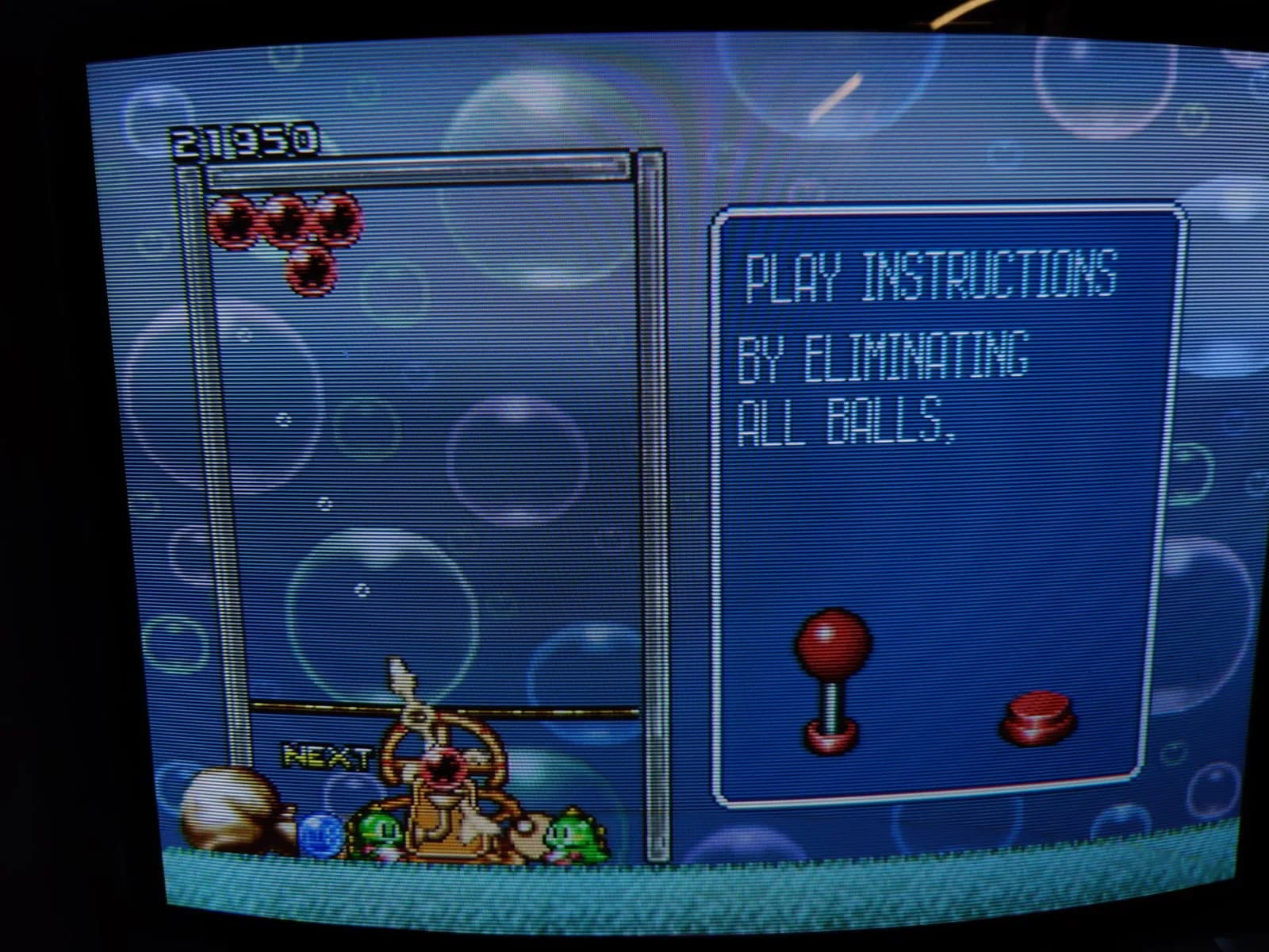 The Panasonic FZ-1 3DO running Puzzle Bobble (Bust-A-Move) via the ODE, on a CRT: a cluster of red bubbles at top, score 21950, and a "PLAY INSTRUCTIONS BY ELIMINATING ALL BALLS" panel with a joystick and button on the right.
