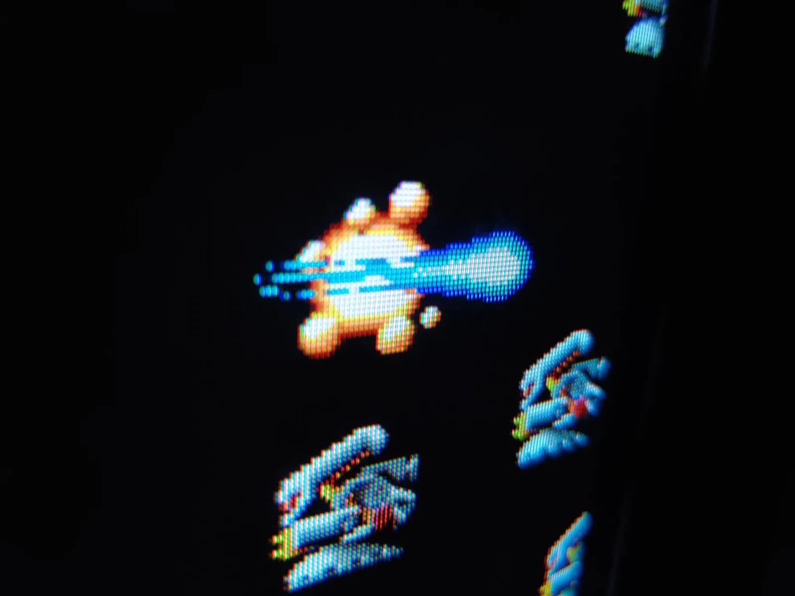 Close-up of the R-Type demo on the Sony PVM-9041Q, no player ship in frame, just enemy craft and a player shot that has struck and exploded an enemy.
