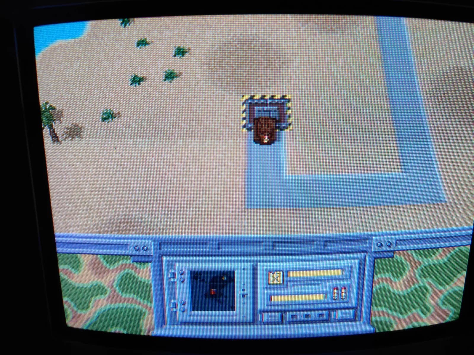 Return Fire on the Panasonic FZ-1 3DO via the ODE, on a Sony PVM-9041Q: a top-down battlefield with sandy terrain, palm trees and small vehicles, one unit selected in a dashed box, and a camouflage-pattern HUD with a radar inset.