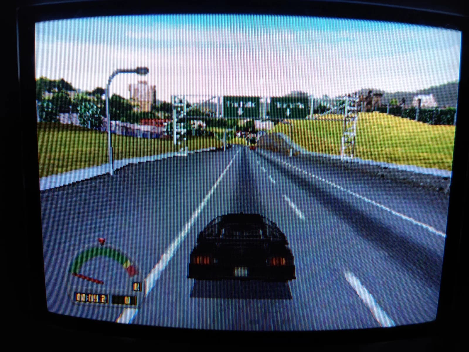The Need for Speed on the Panasonic FZ-1 3DO via the ODE, shown on a Sony PVM-9041Q: a third-person chase view behind a dark sports car on a two-lane road with grass verges and streetlights, plus a speedometer and lap timer in the HUD.