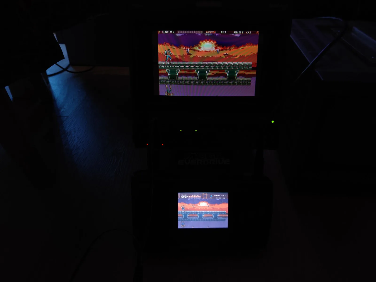 Sega Nomad displaying Castlevania gameplay on two screens during restoration testing after capacitor replacement.