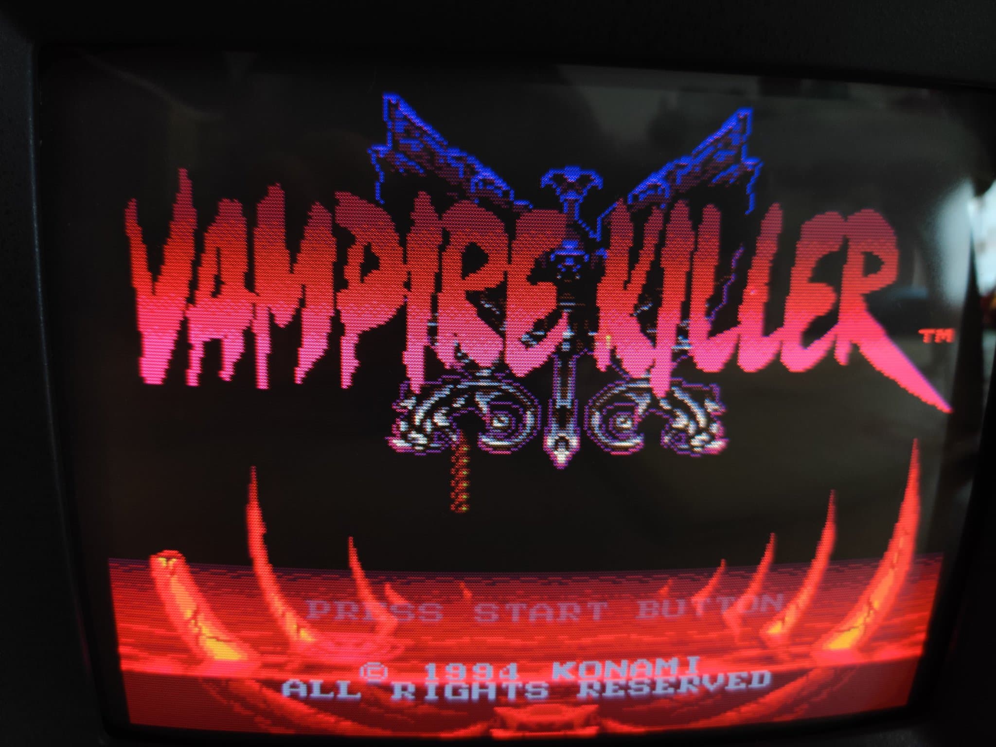 Ikegami TM10-17RA CRT showing the Vampire Killer (Castlevania: Bloodlines, Konami 1994) title screen, a red logo with a blue crest and a Press Start prompt.