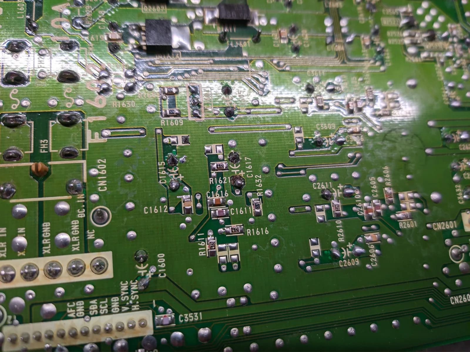 Close-up of the solder side of the Sony BVM-D9H5J D board (deflection board): a blobbed solder joint at C1617 where the pad on this side had been obliterated by a previous servicer, the blob bridging it to keep continuity in the circuit, among solder joints, traces and silkscreen designators including C1611, C1612, R1609 and R1621.