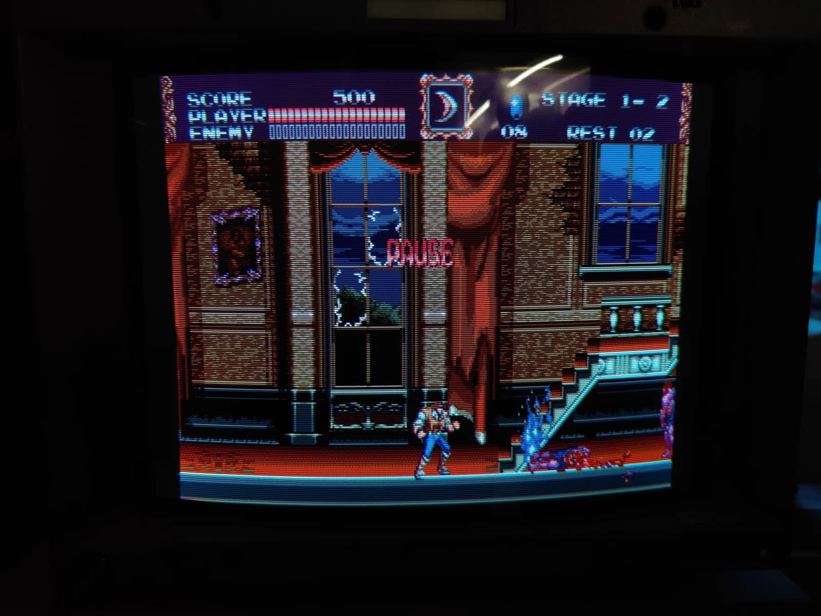 Castlevania Bloodlines (Sega Mega Drive) on the Sony BVM-D14H1E, paused on a gothic mansion interior with the HUD at Stage 1-2 and crisp scanlines; post-recap testing in the cap-kit thread.