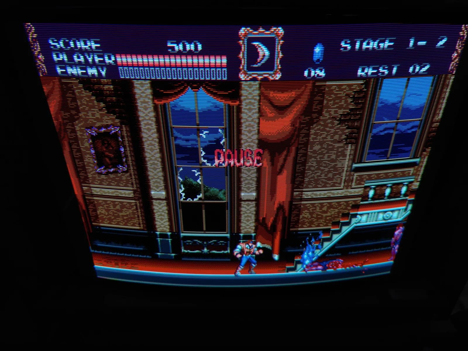 Castlevania Bloodlines (a Sega Genesis title) paused on the 800TVL Sony BVM-D14H1E, the gothic mansion scene showing crisp scanlines and the tube's curvature, HUD at Stage 1-2; post-recap testing.