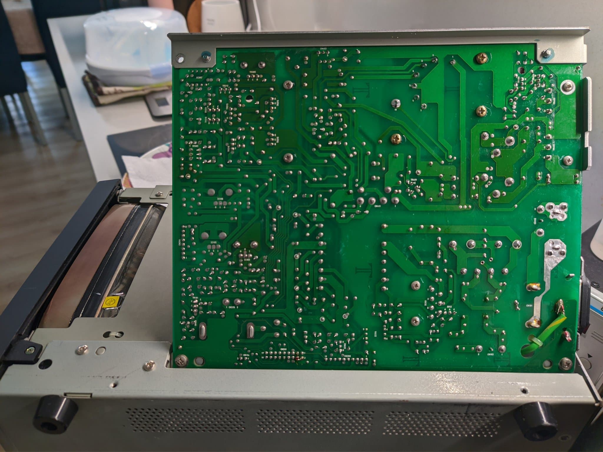 Solder side of the Ikegami TM10-17RA power supply board, showing the two empty holes where the J101 jumper link was removed for the 200-240V reconfiguration.