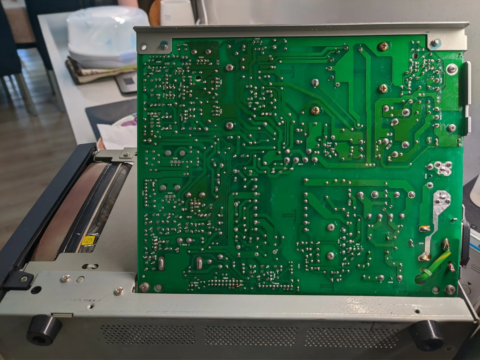 Solder side of the Ikegami TM10-17RA power supply board, showing the two empty holes where the J101 jumper link was removed for the 200-240V reconfiguration.