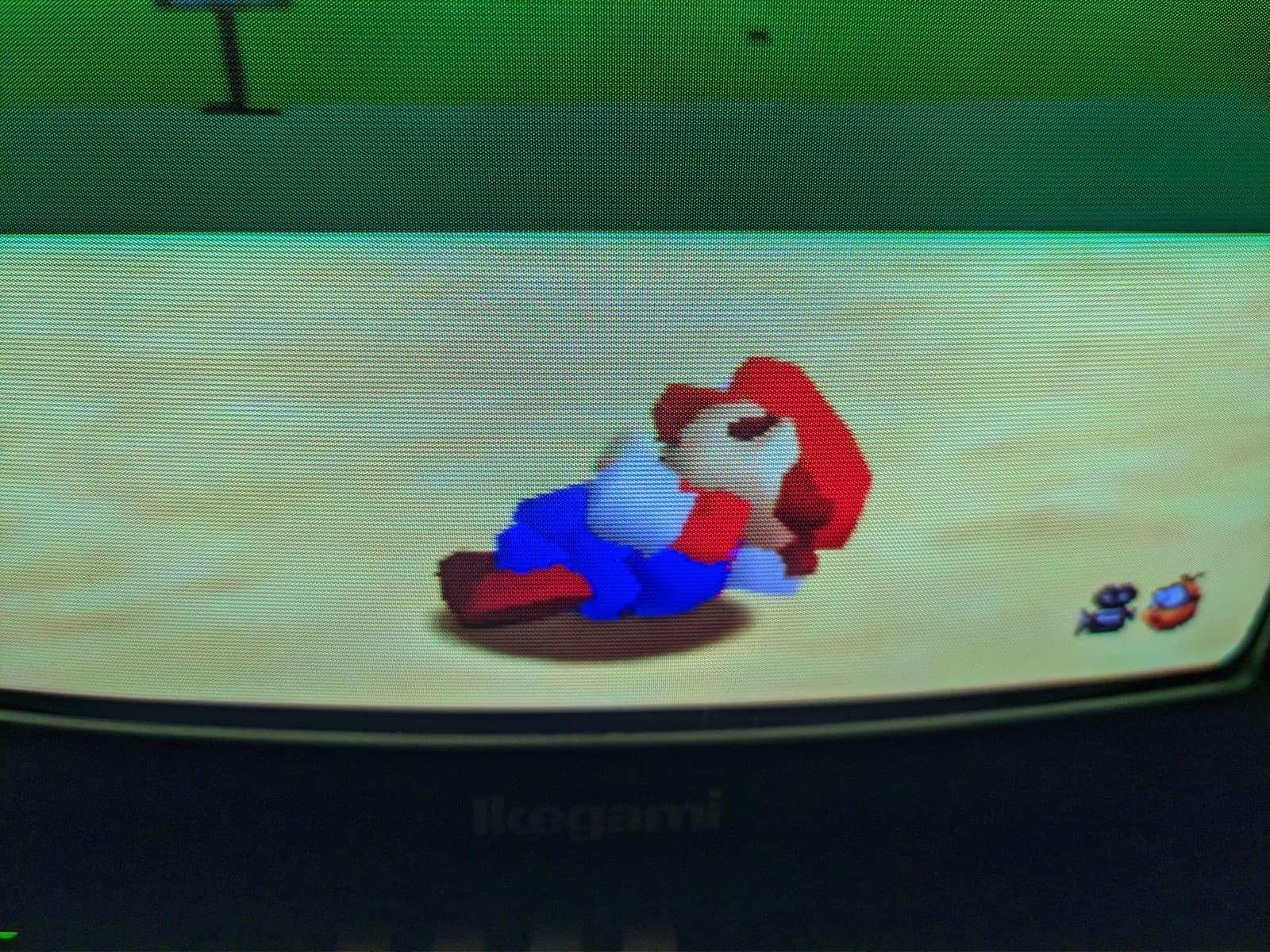 Super Mario 64 (N64) on the Ikegami TM10-17RA CRT, the macro showing the shadow-mask phosphor dot pattern, Ikegami bezel below.