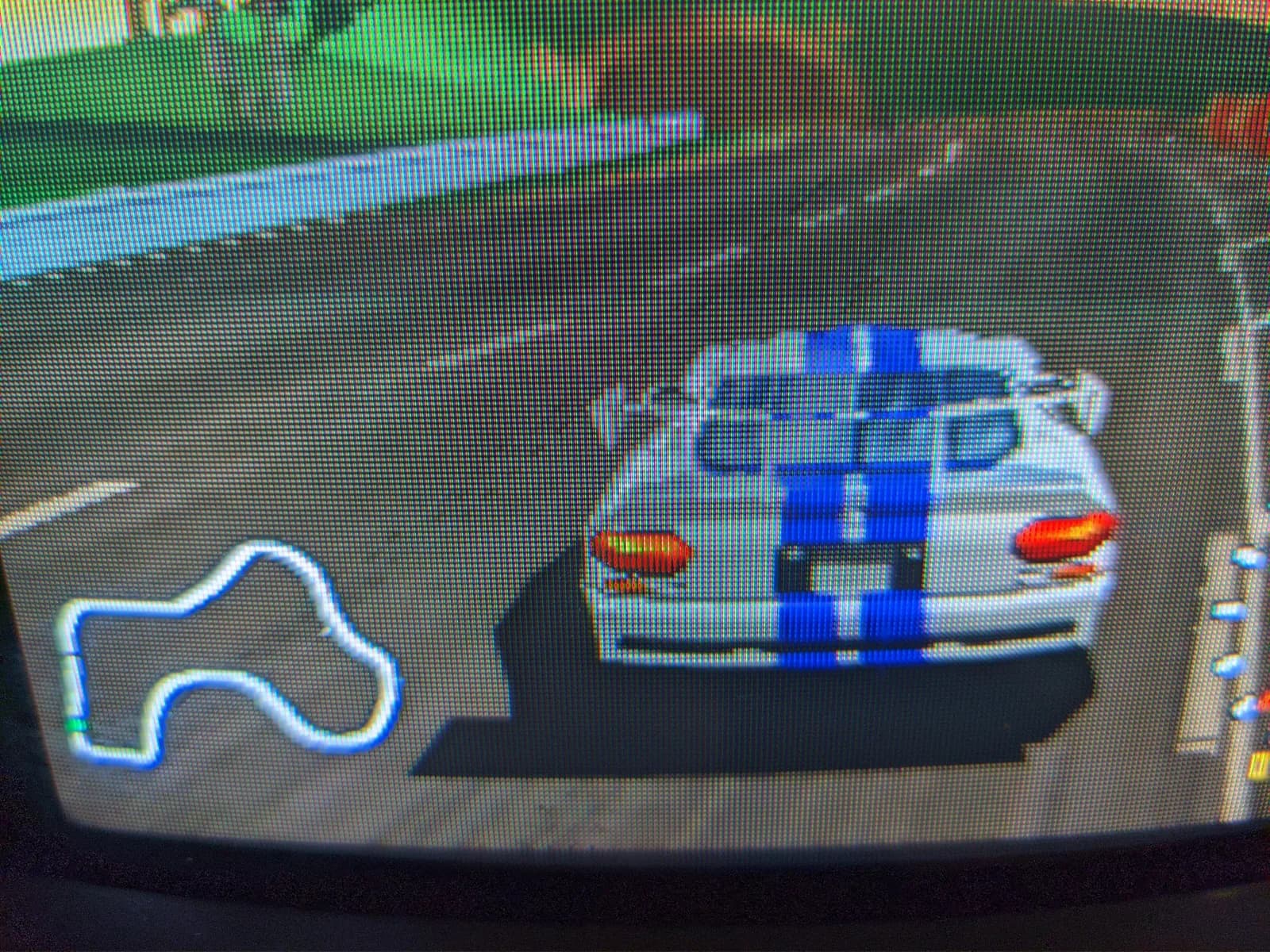 N64 World Driver Championship displayed on Sony PVM-9040 CRT in normal resolution mode; blue and white race car on track with red tail lights visible.