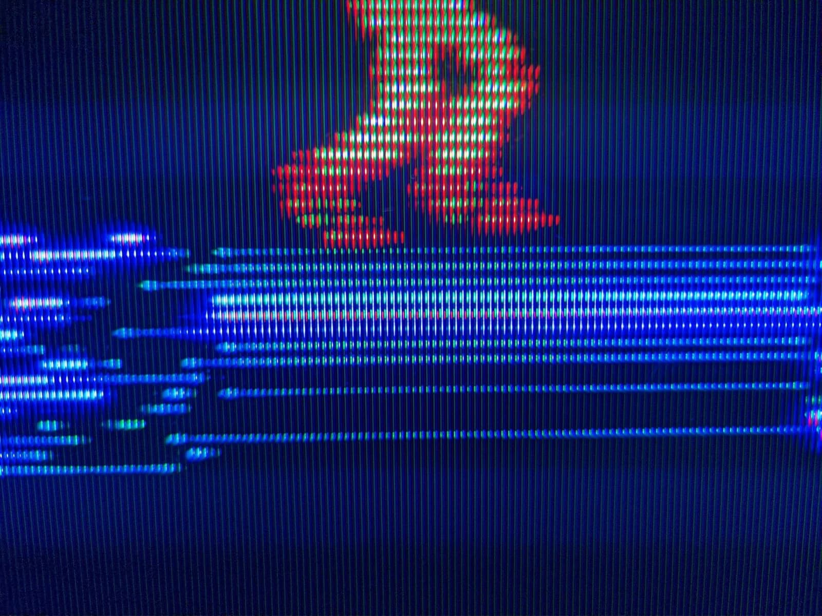 Famicom composite test on the Sony KV-29FX30E showing in-game Metroid, the red and orange Samus sprite standing above a bright blue platform in the level, with scanlines across the picture.