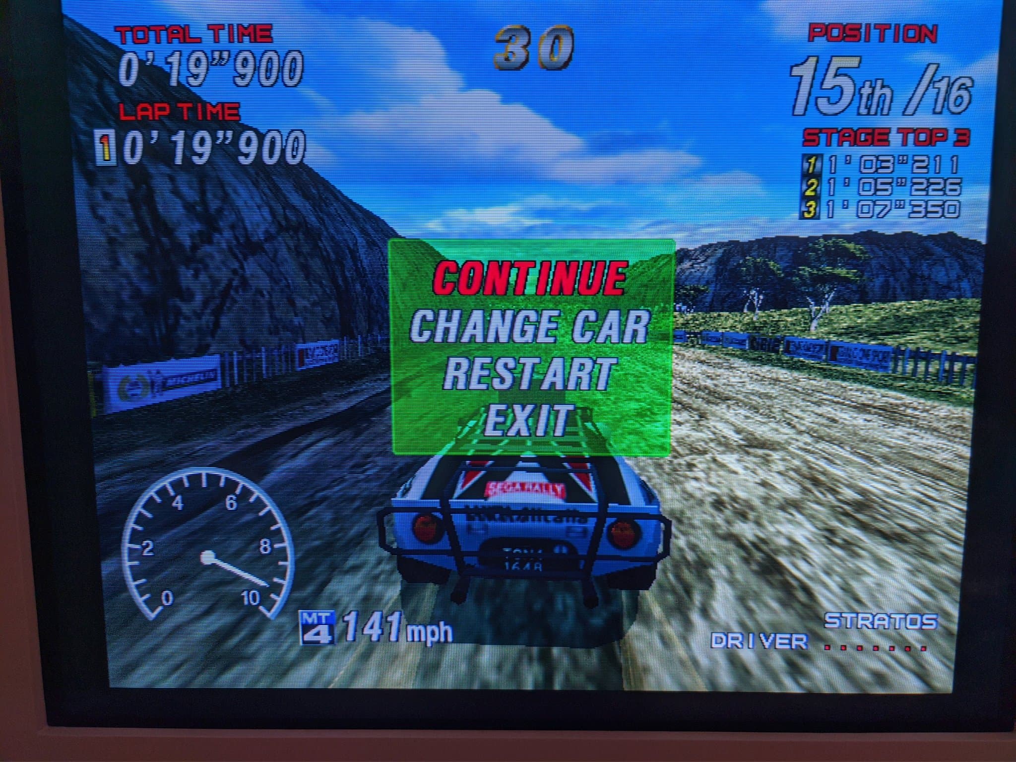 Sega Rally 2 paused on the Sony CPD-G420, green pause menu (Continue, Change Car, Restart, Exit) over the HUD with speedometer, position and lap times.