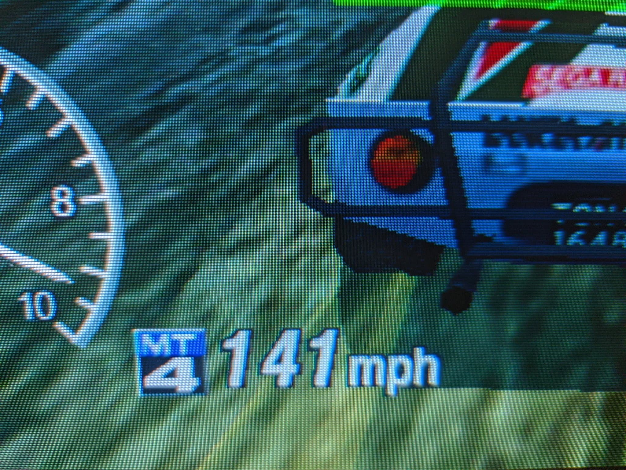 Close-up of Sega Rally 2 on the Sony CPD-G420, the HUD reading 141 mph in MT 4 gear, rear of the rally car with its SEGA RALLY decal.