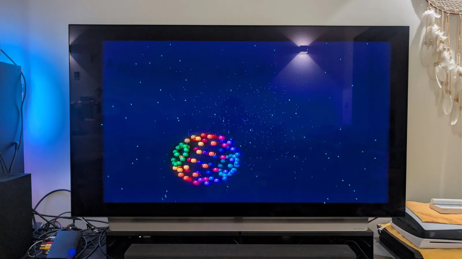 FM Towns Marty displaying colorful bouncing ball demo on blue starfield background after successful restoration and recapping.