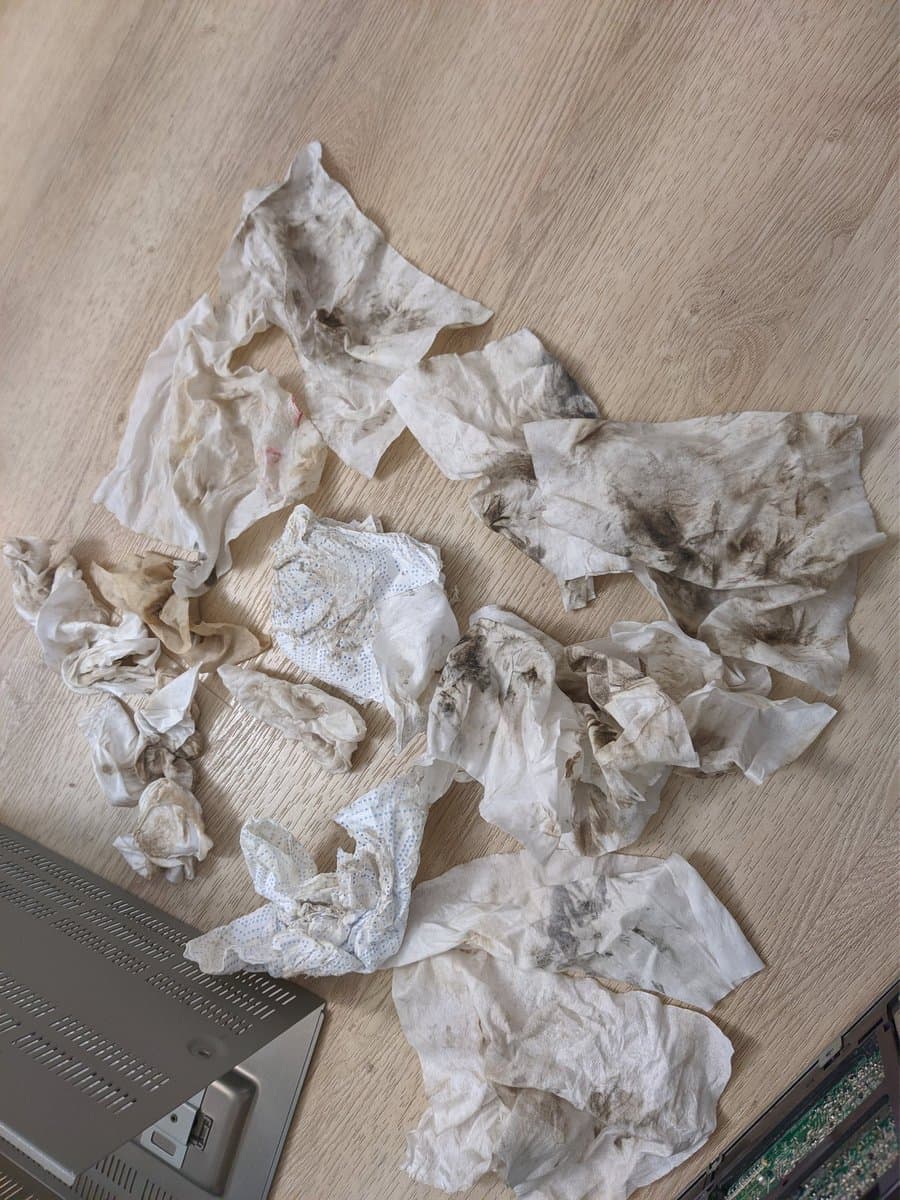 Used tissues and cleaning materials from Sony BVM-9045QD restoration, showing heavy nicotine and dust buildup removal during CRT monitor restoration process.