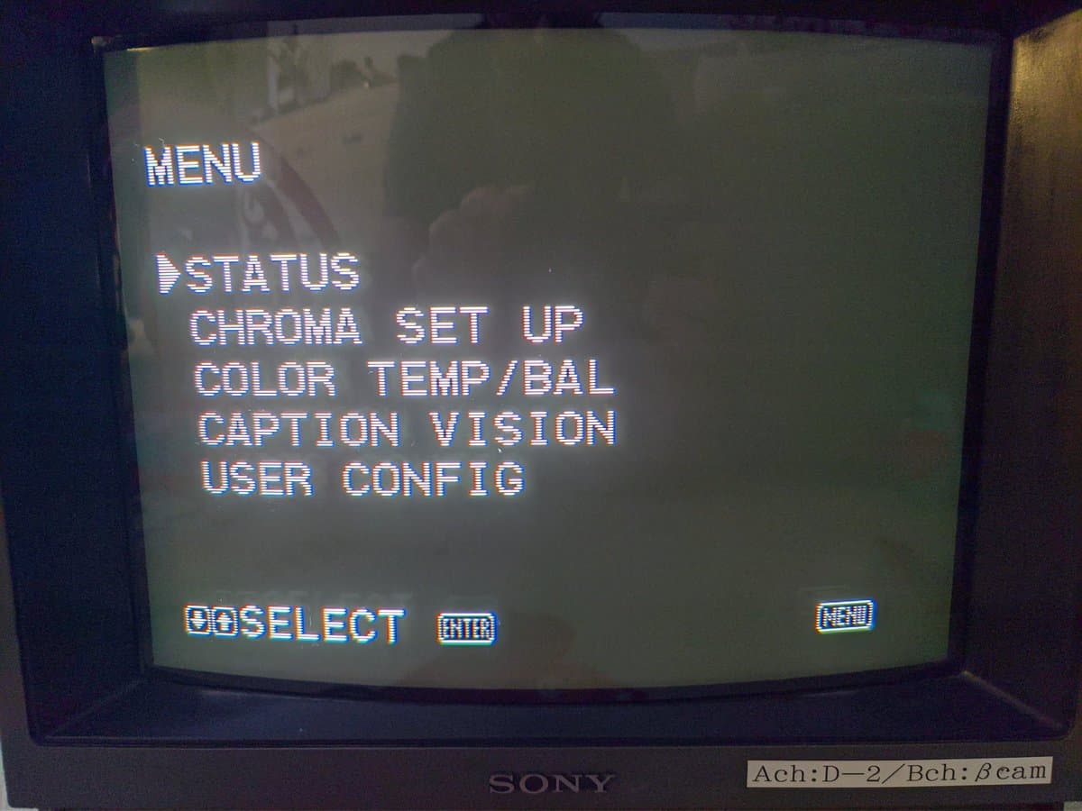 Sony PVM-14M4J menu screen showing STATUS, CHROMA SET UP, COLOR TEMP/BAL, CAPTION VISION, and USER CONFIG options during post-repair testing.