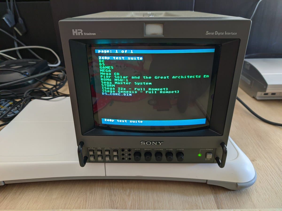 Sony BVM-9045QD displaying 240p test suite menu showing console ROM list; restoration in progress for missing color channel issue.