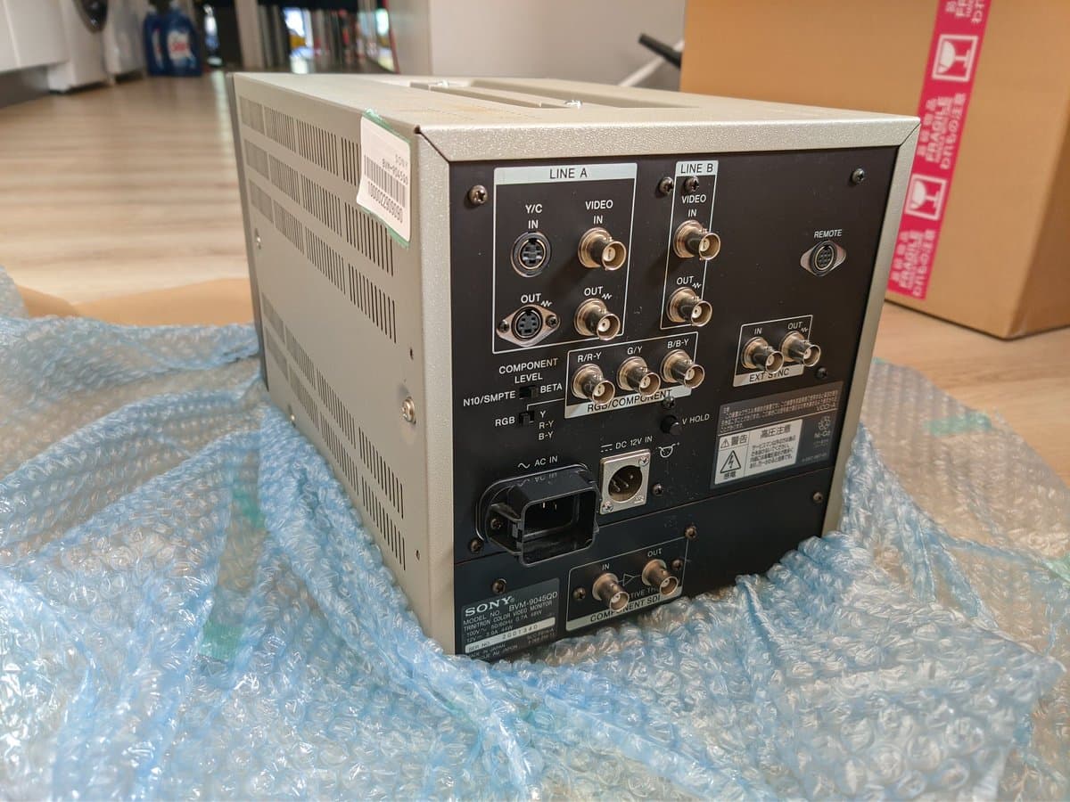 Sony BVM-9045QD rear panel showing video inputs, RGB connectors, component level controls, and AC power inlet during restoration work.