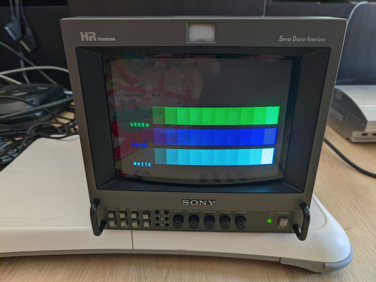 Sony BVM-9045QD displaying color test pattern with green, blue, and white bars; restoration in progress after arriving with missing color channel.