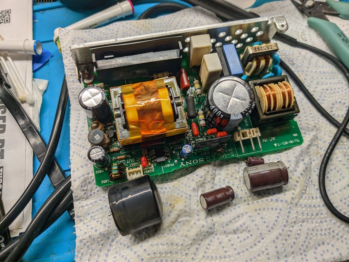 Recapped Sony BVM-9045QD PSU board with new capacitors, showing transformer, inductor coils, and electrolytic caps replaced during restoration.