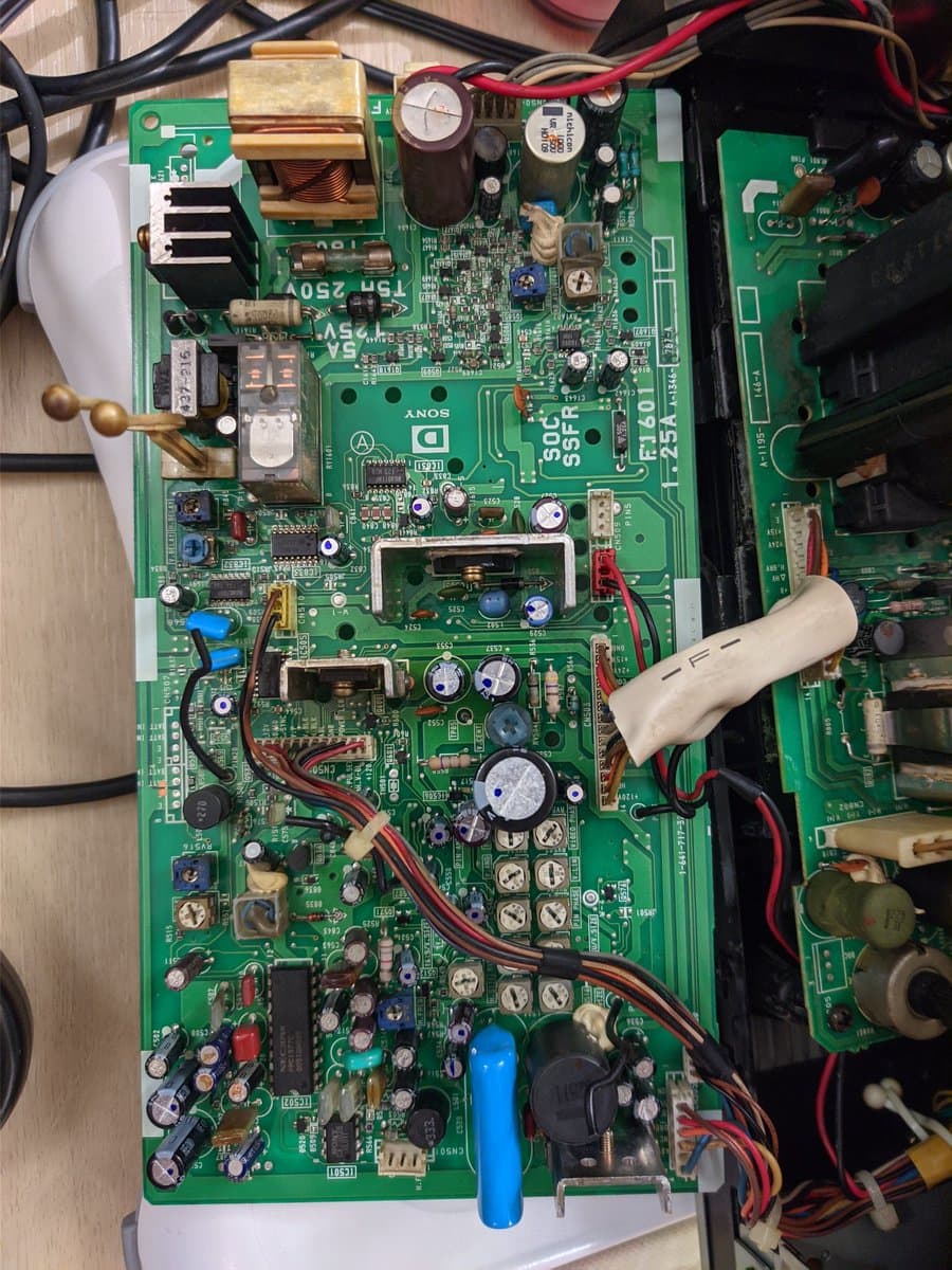 Sony BVM-9045QD deflection board with reflowed solder joints, showing capacitors, transistors, and connectors during restoration work.