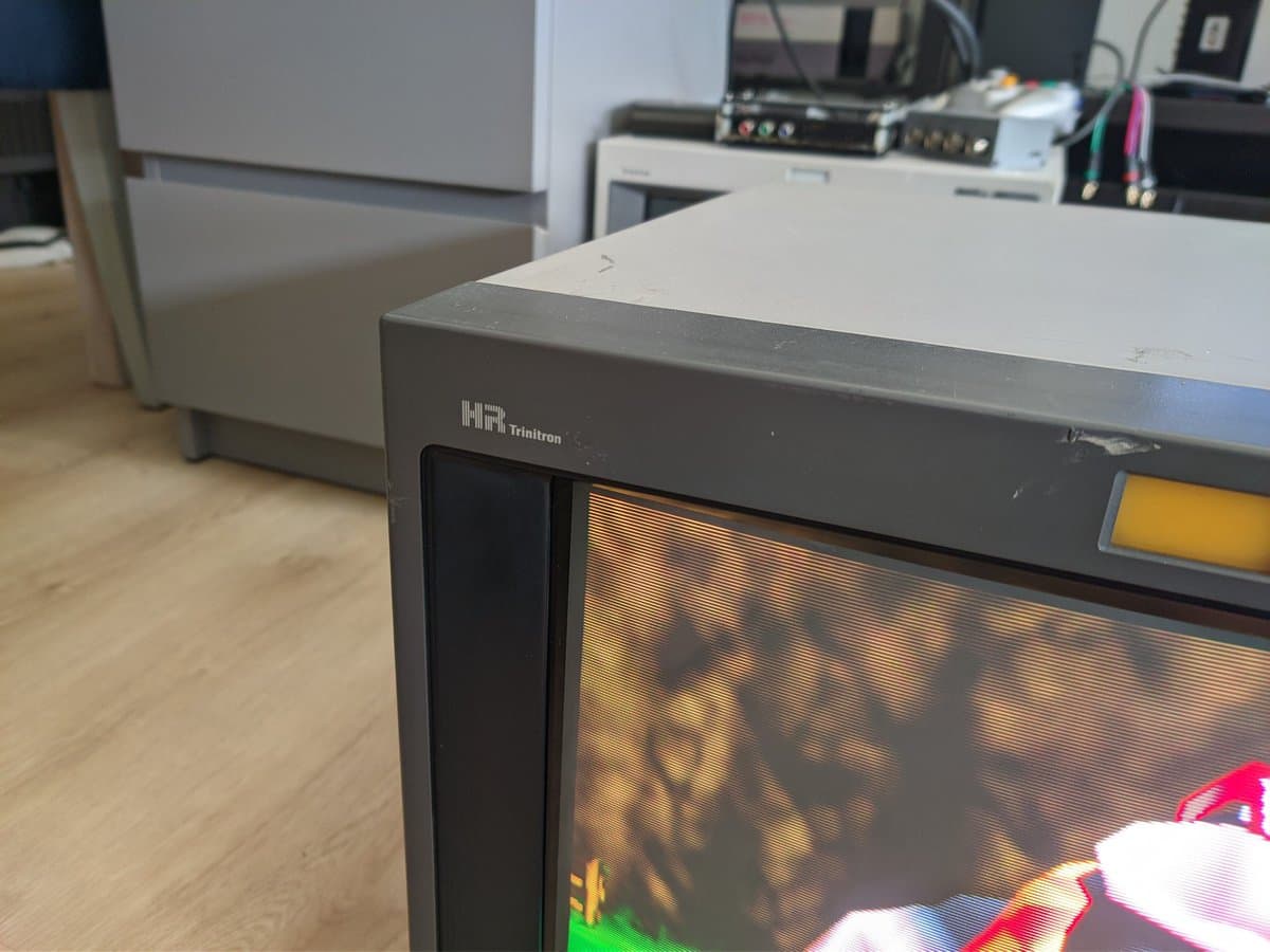 HR Trinitron CRT monitor displaying colorful test pattern during repair verification after resolving retrace lines and reflowing main board solder joints.