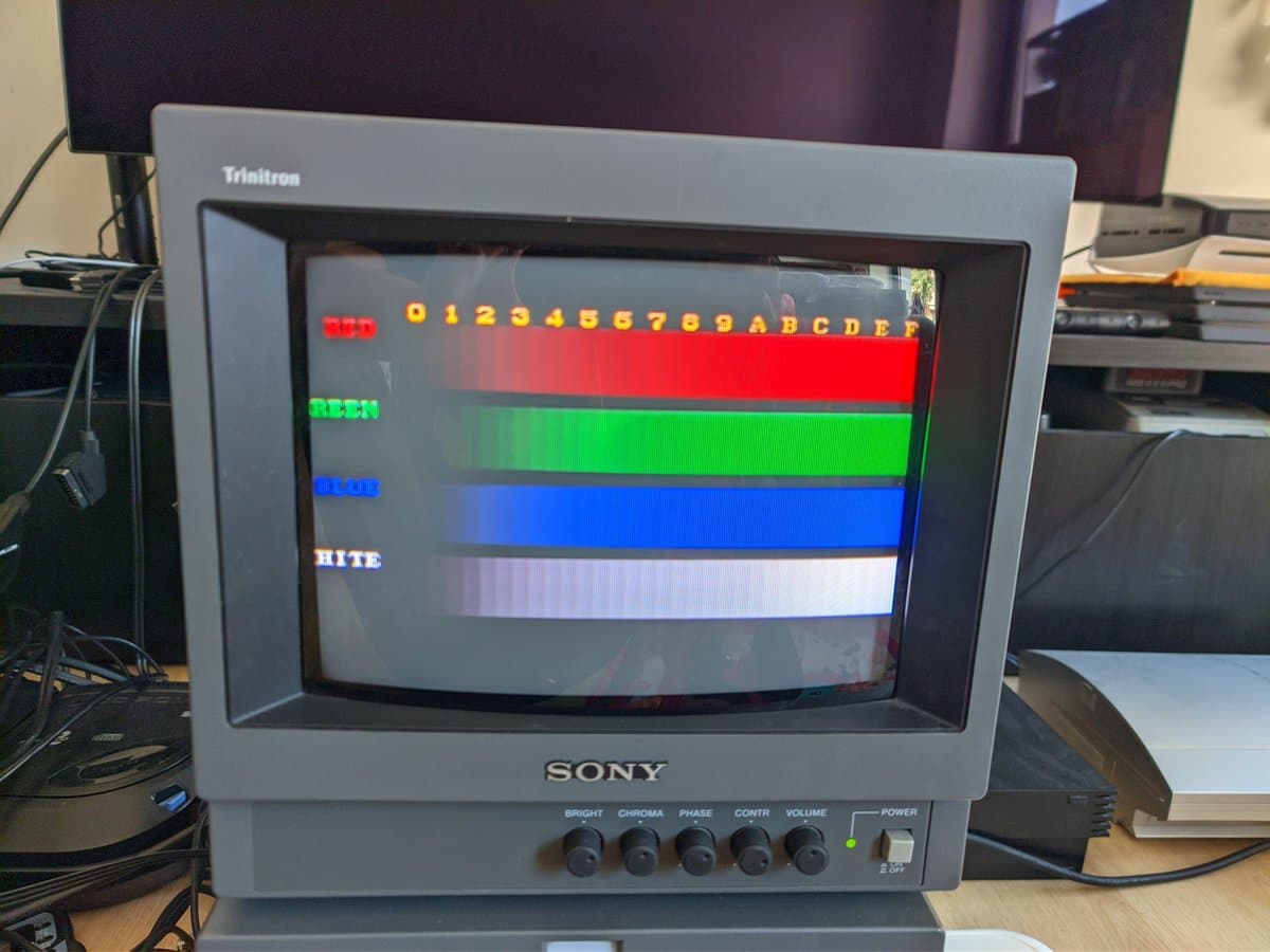 Sony PVM-9040 displaying color test pattern with red, green, blue, and white horizontal stripes showing color output issues.